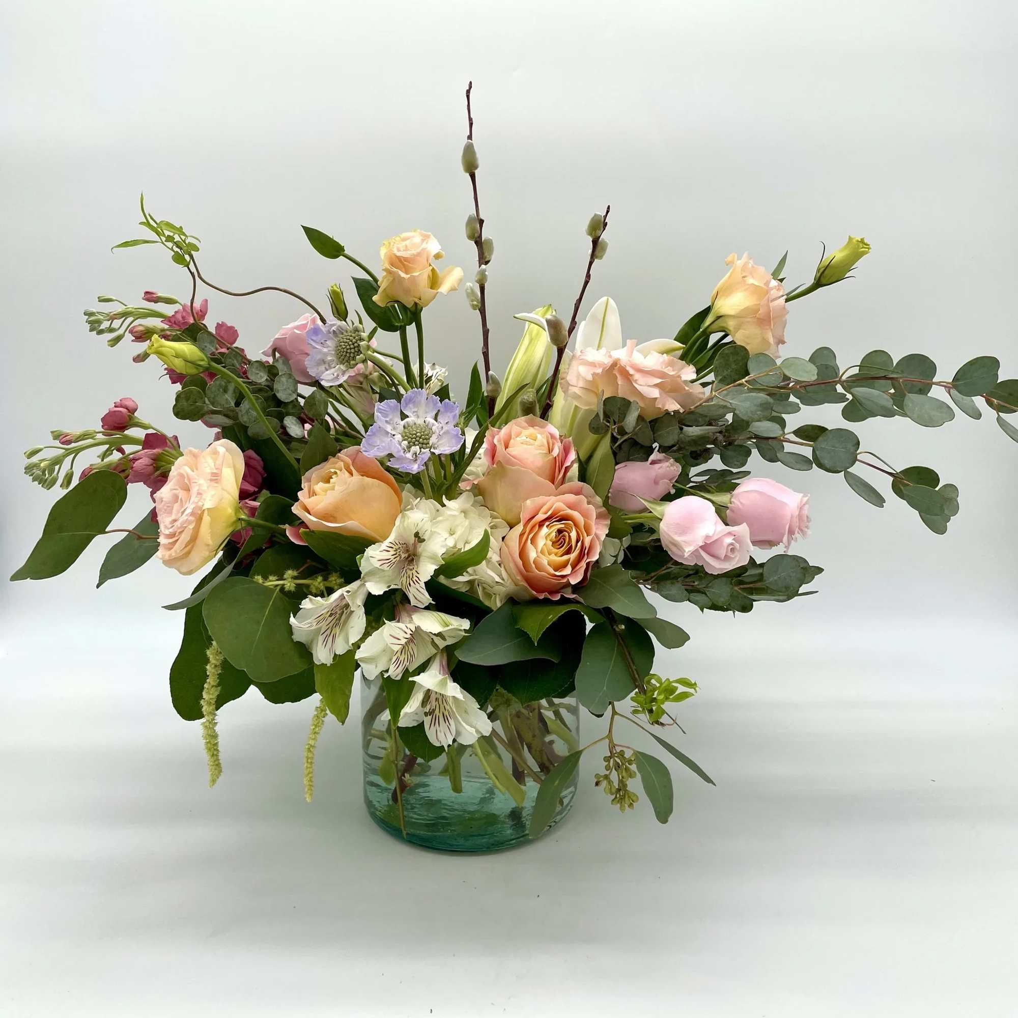 A soft, low and lush arrangement made of whites, pinks and peaches