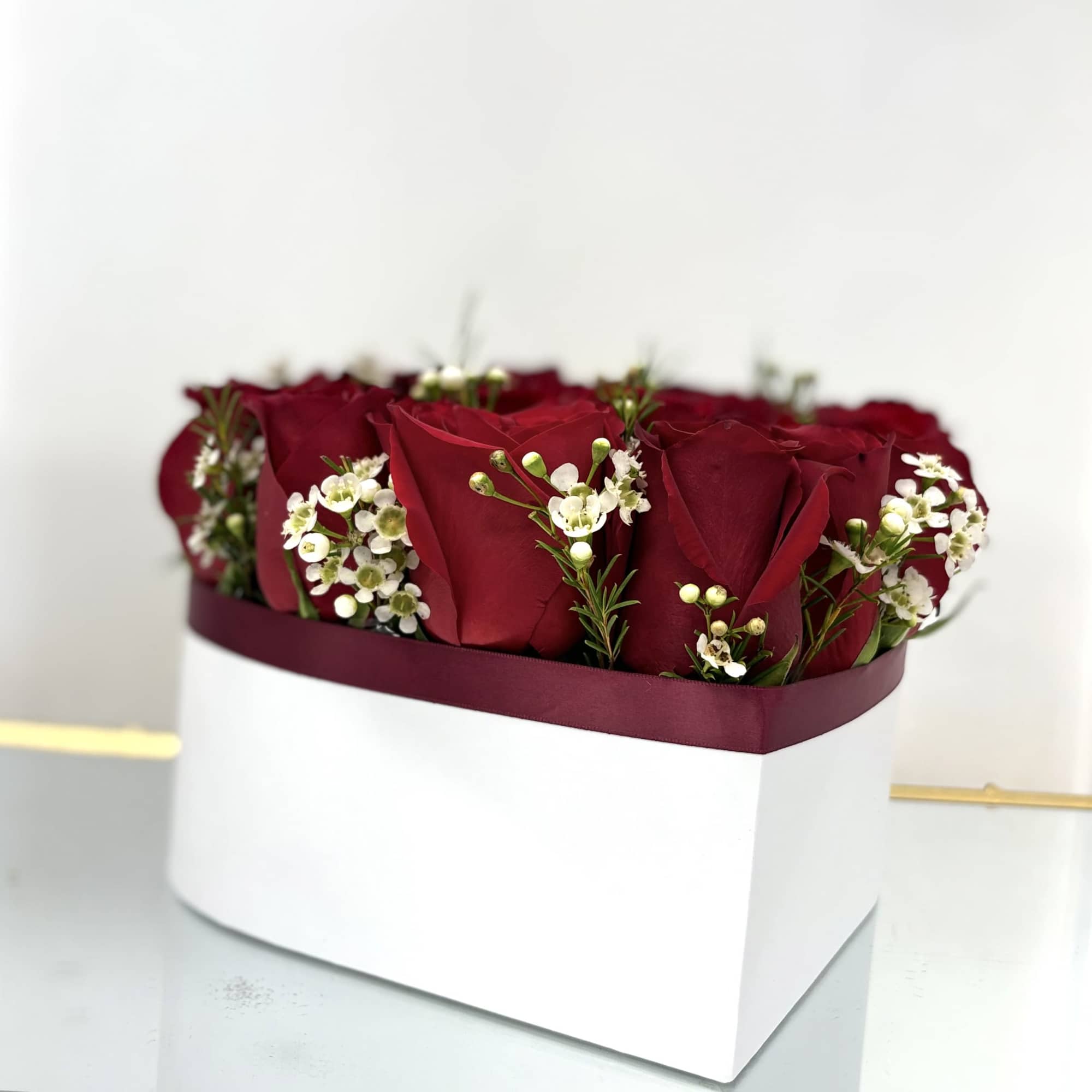 A heart with red roses and wax flowers is a sign of