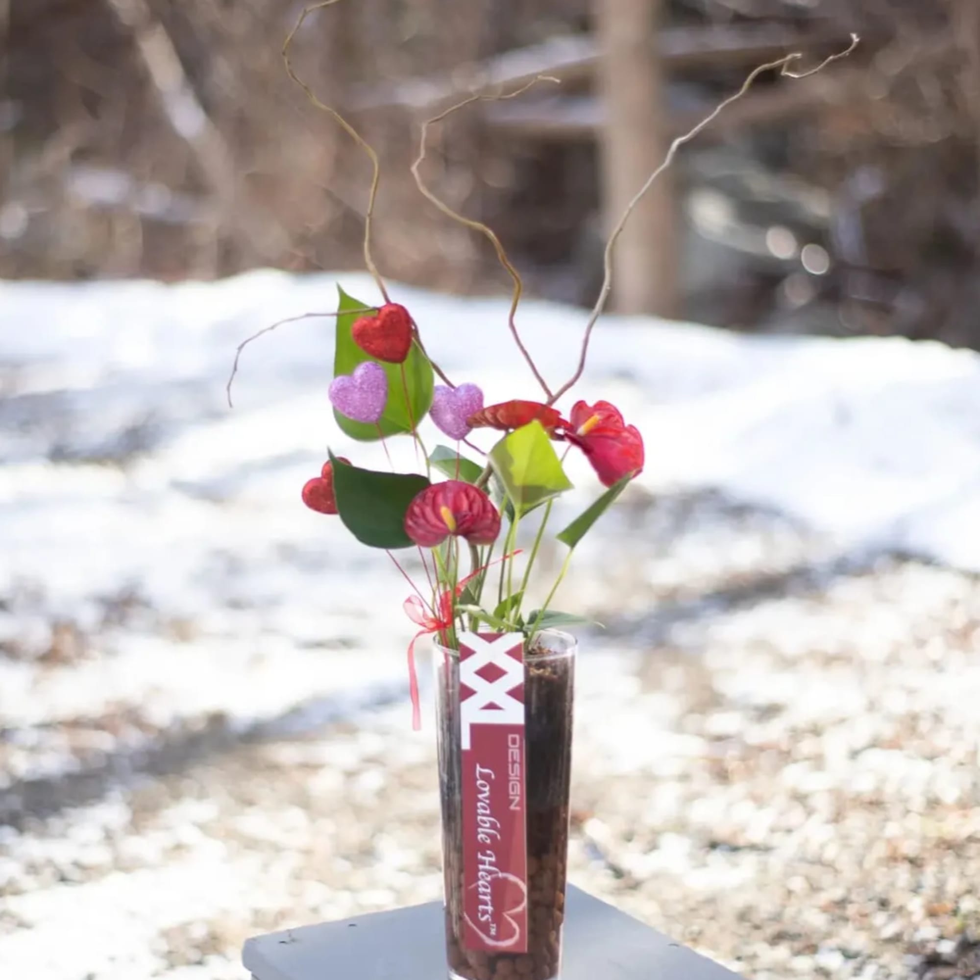 Small vase with heart-shaped flowers and curly twigs