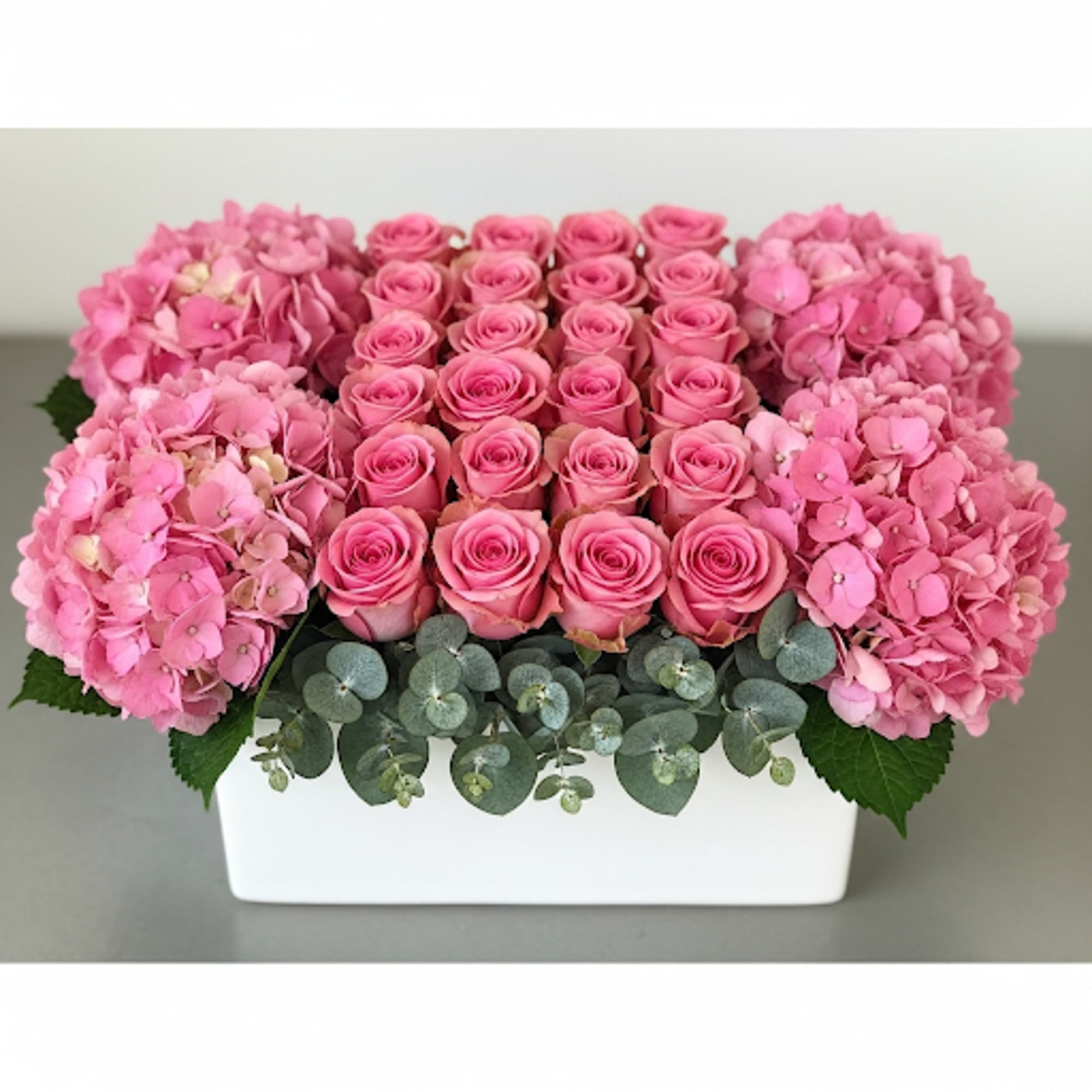 Standard: Square or Round white ceramic depending upon availability. Holland Hydrengeas with