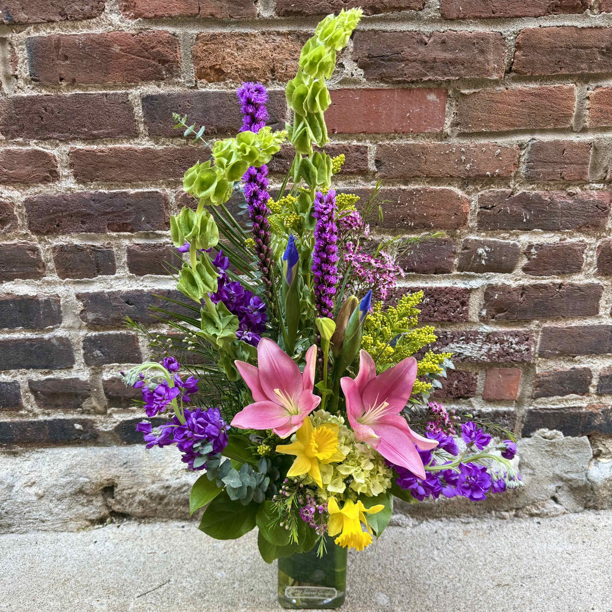 This stunning and unique arrangement showcases the Spring season with a burst