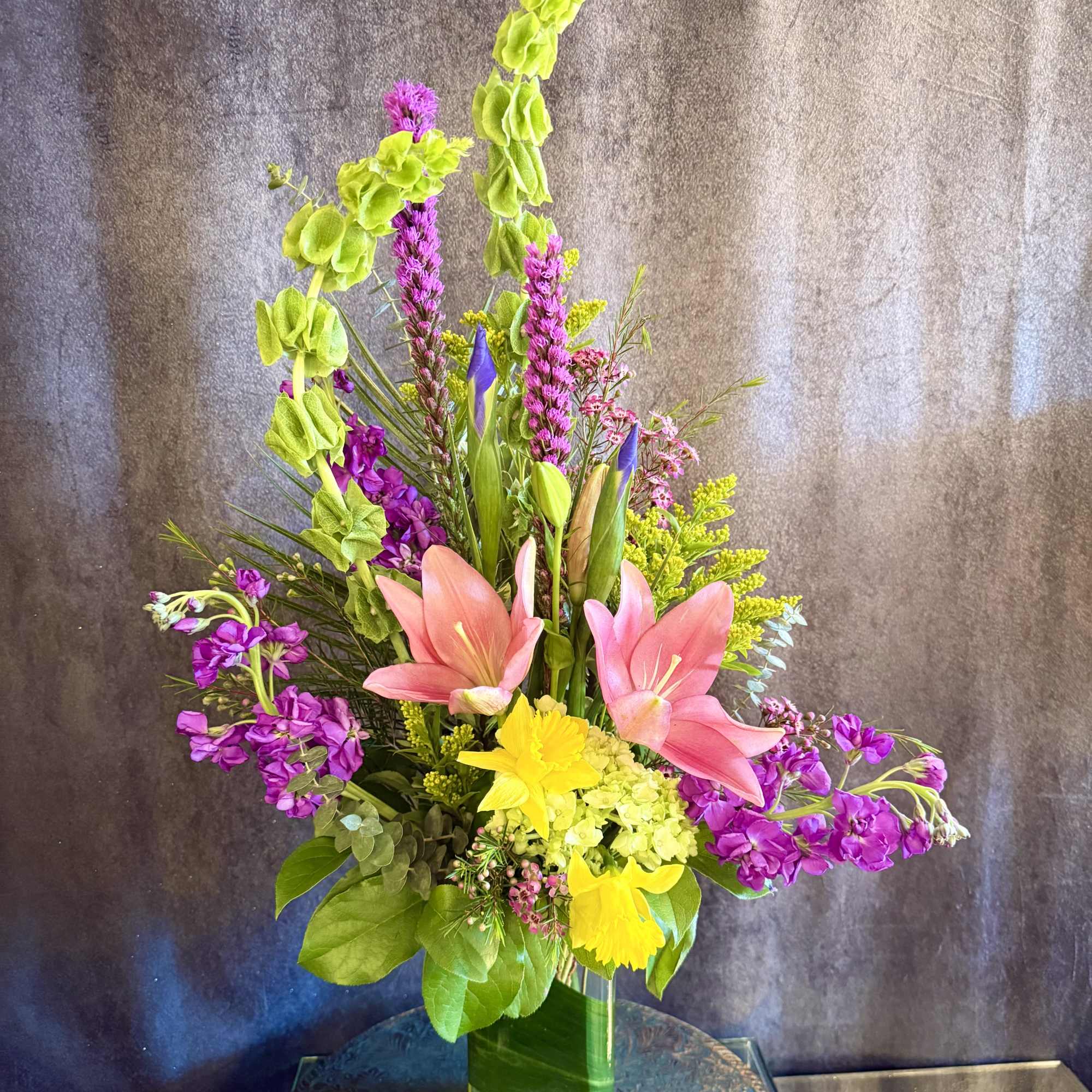 This stunning and unique arrangement showcases the Spring season with a burst