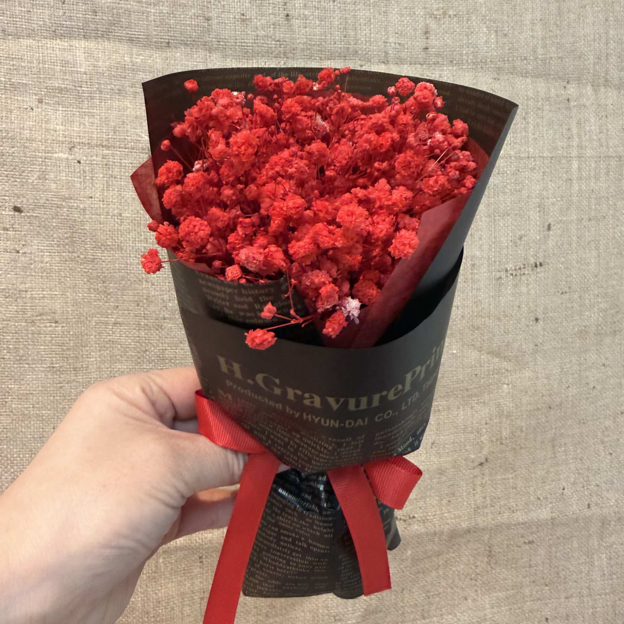 This is a small bouquet of dried flowers full of red stars.