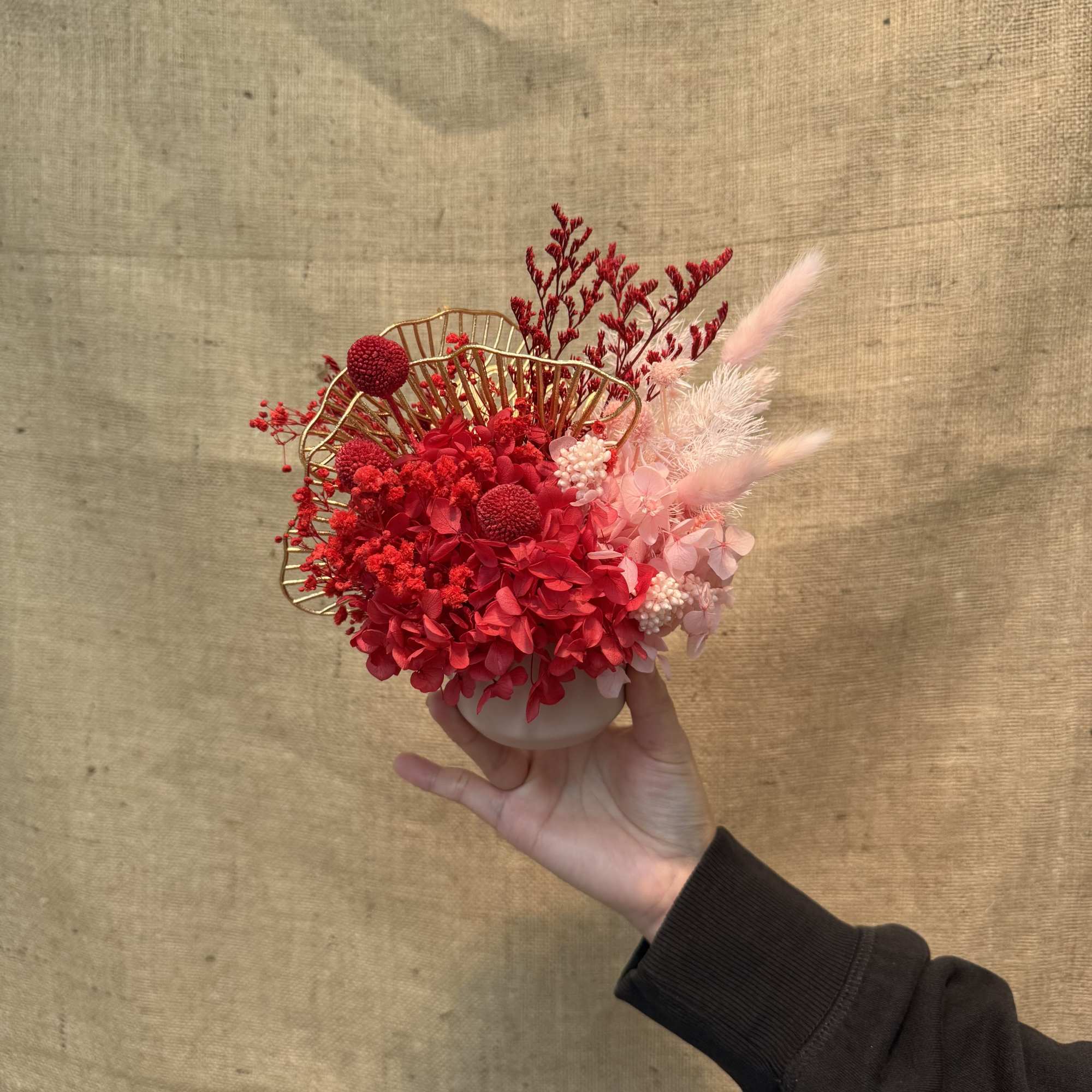 This is an eternal flower or dried flower arrangement with red as