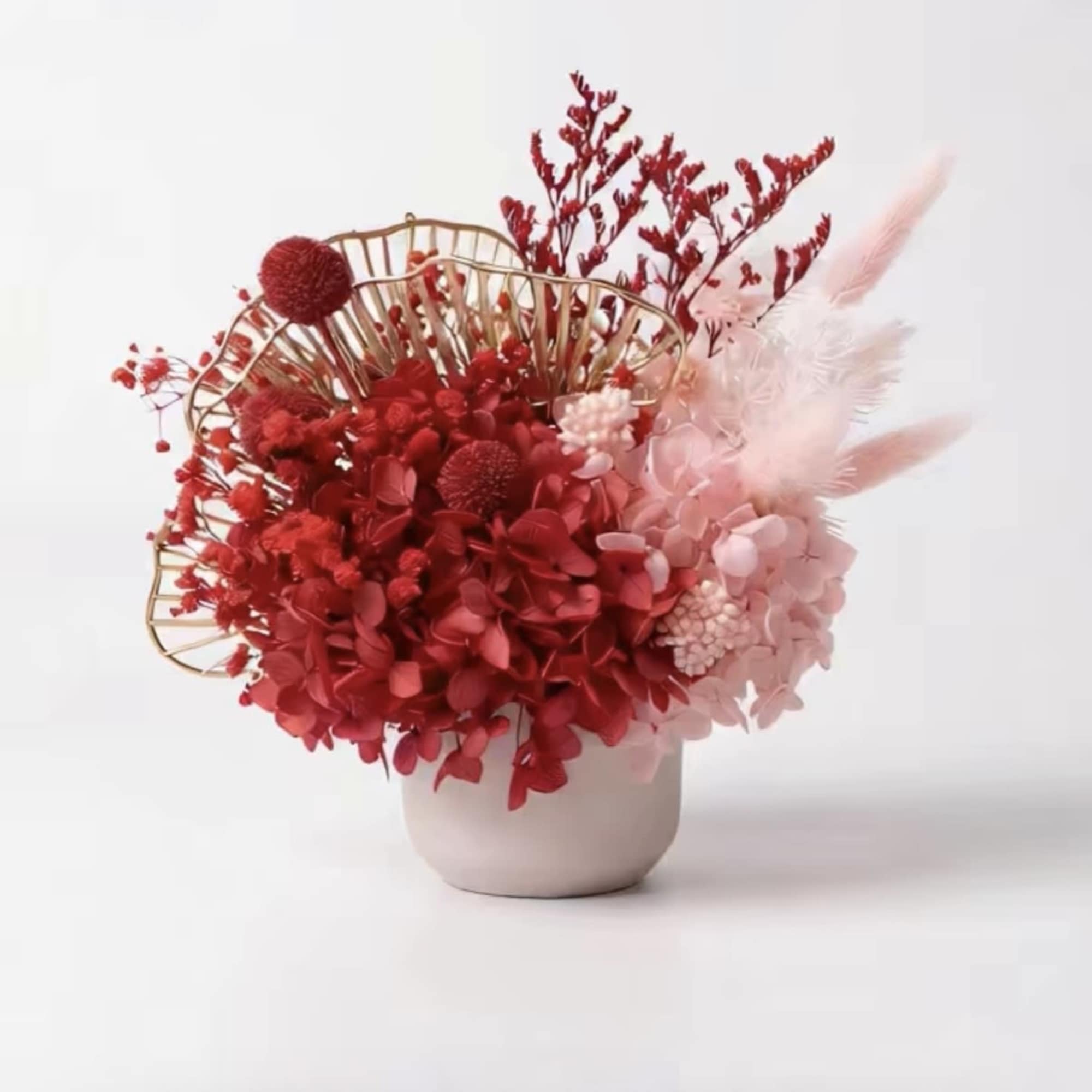 This is an eternal flower or dried flower arrangement with red as