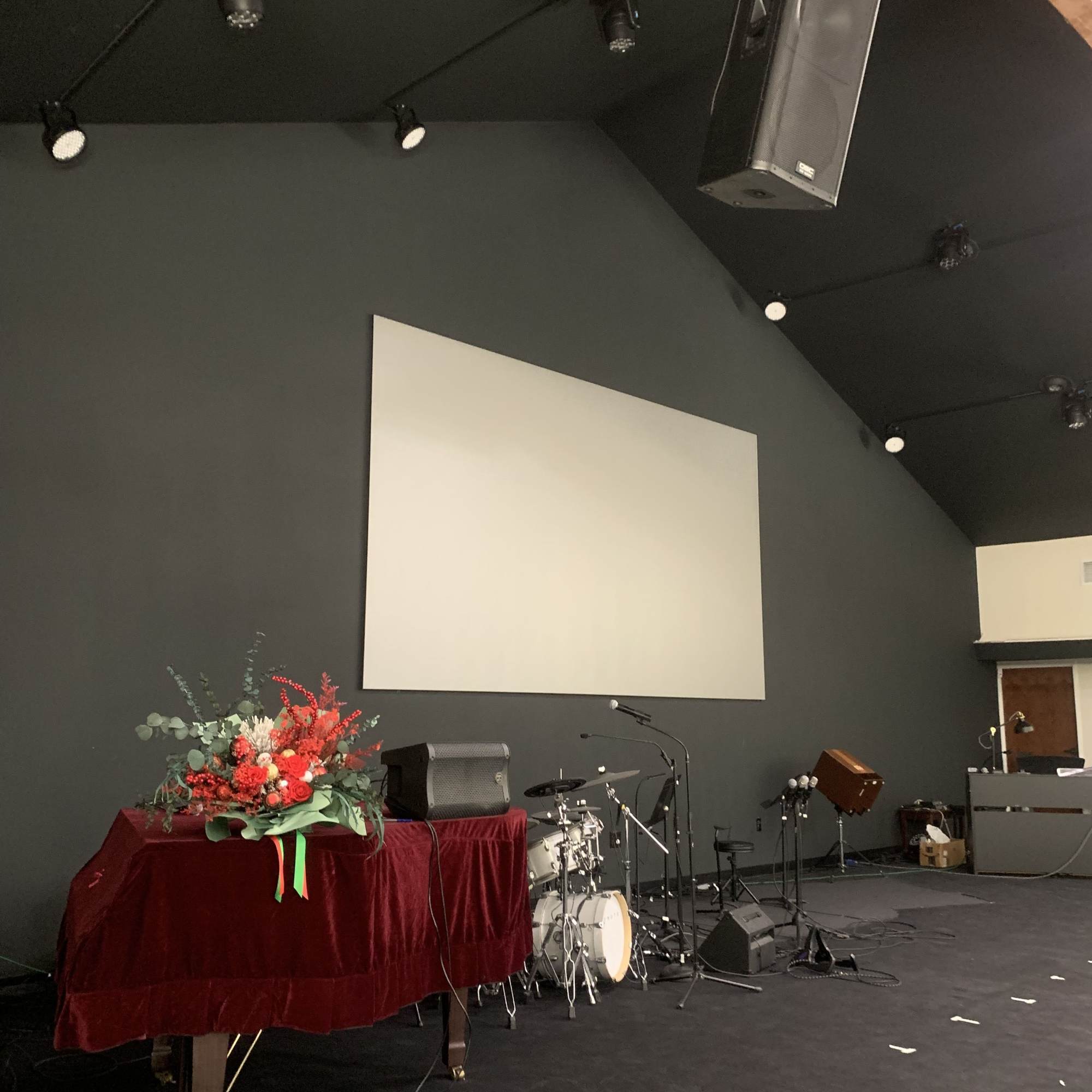 This is a Christmas-themed basket, mainly composed of red roses, eucalyptus leaves