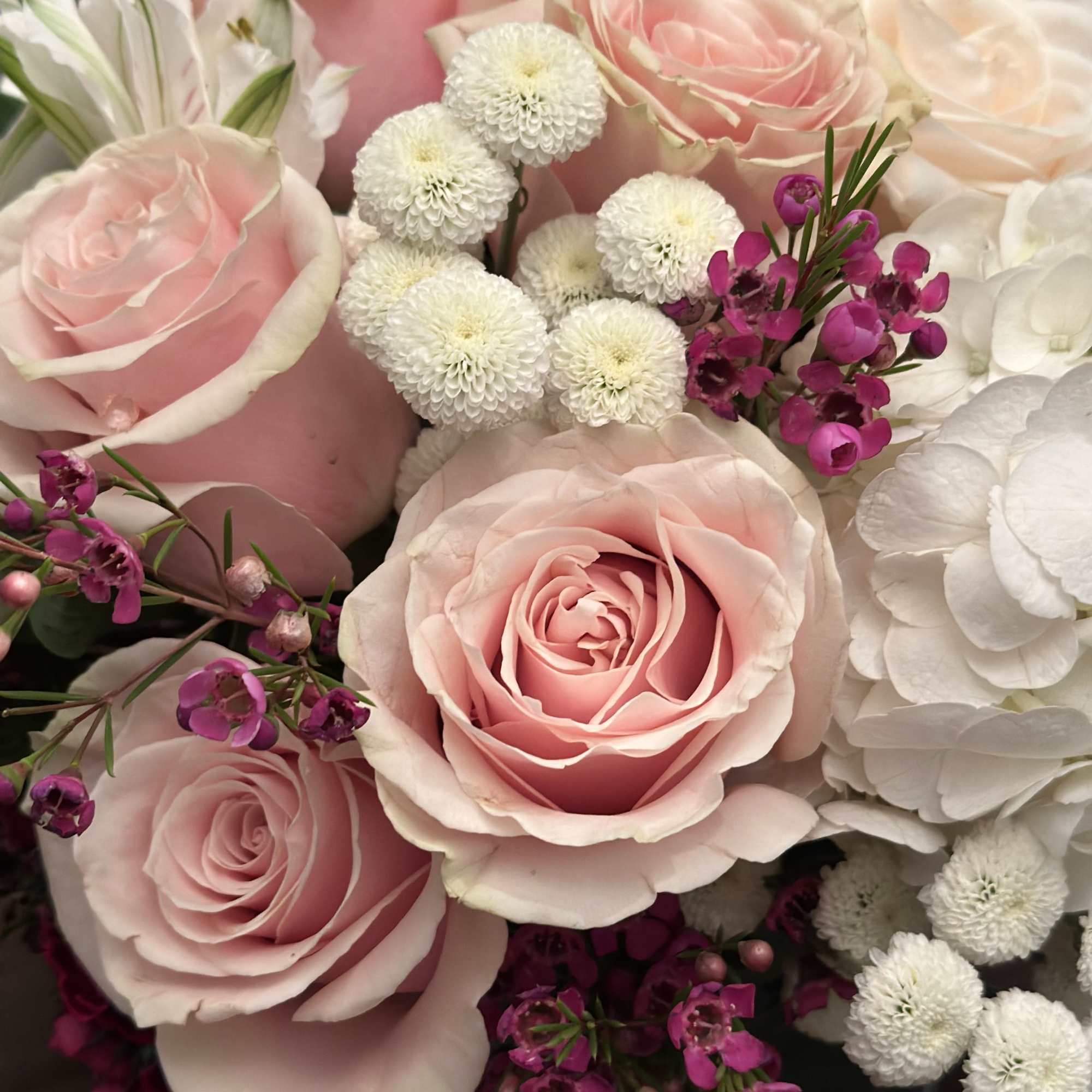 A light and lush arrangement perfect for a centerpiece or just because.