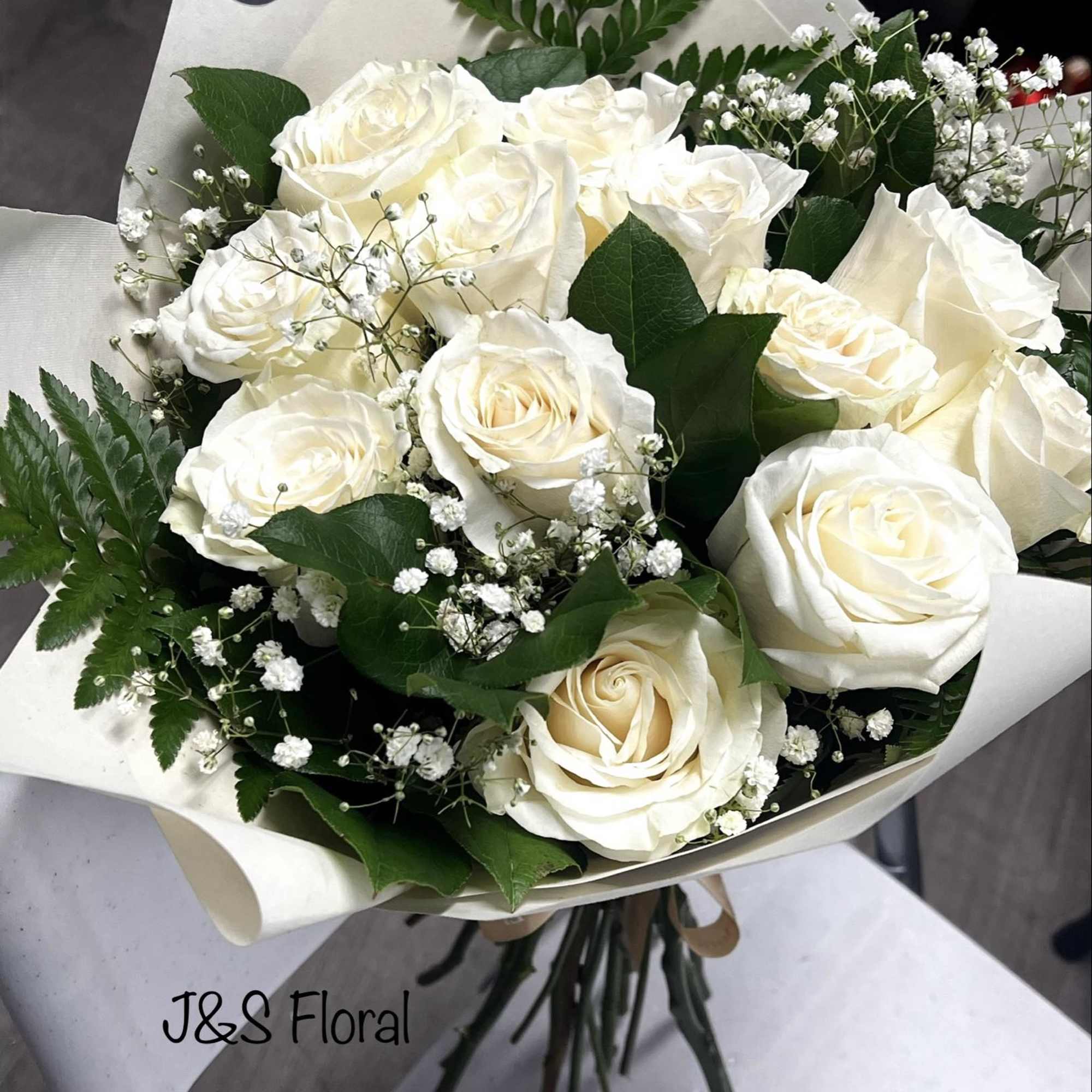Introducing our white roses bouquet, beautifully made with white roses, baby's breath