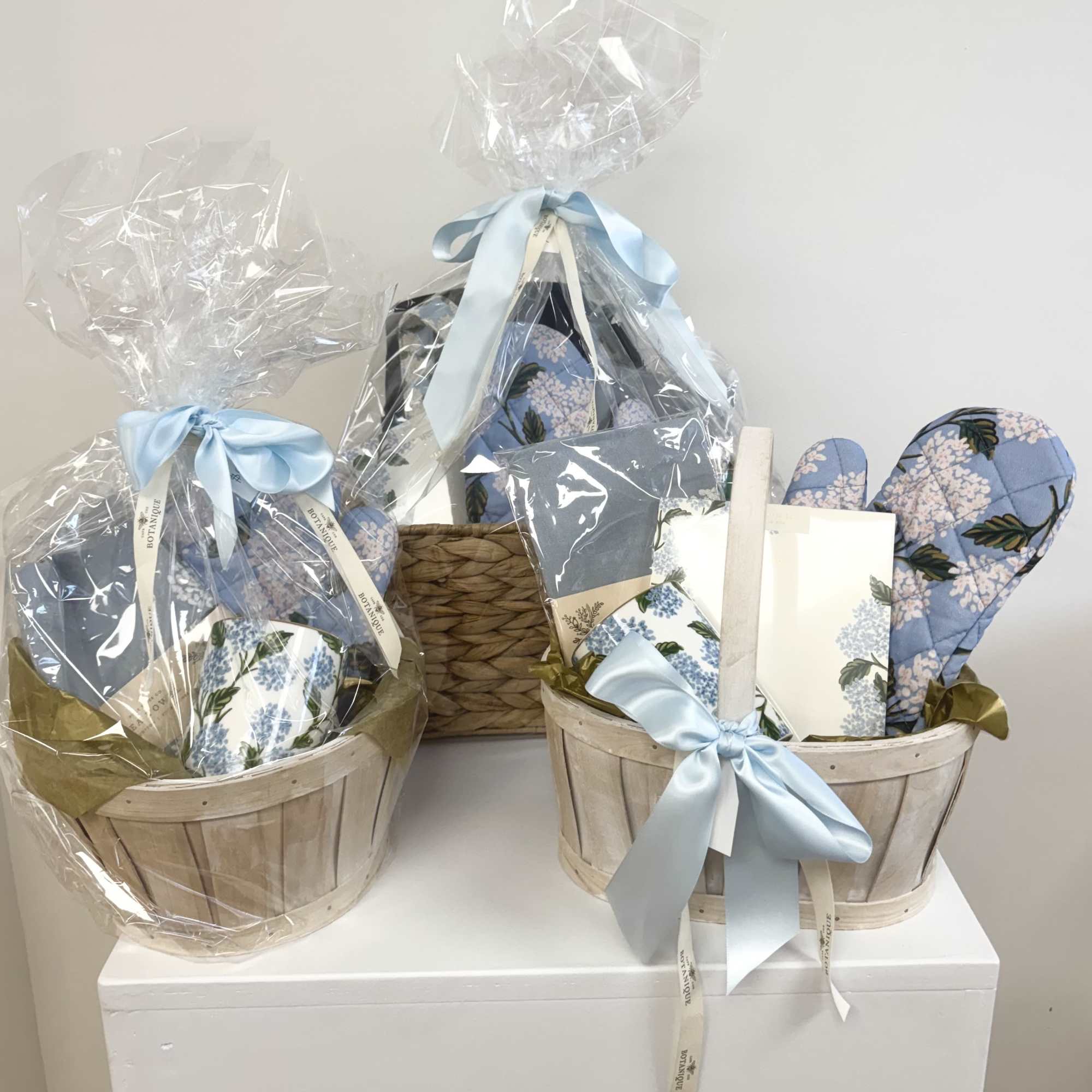 These beautifully curated baskets include hydrangea-inspired gifts such as tea towels, mugs