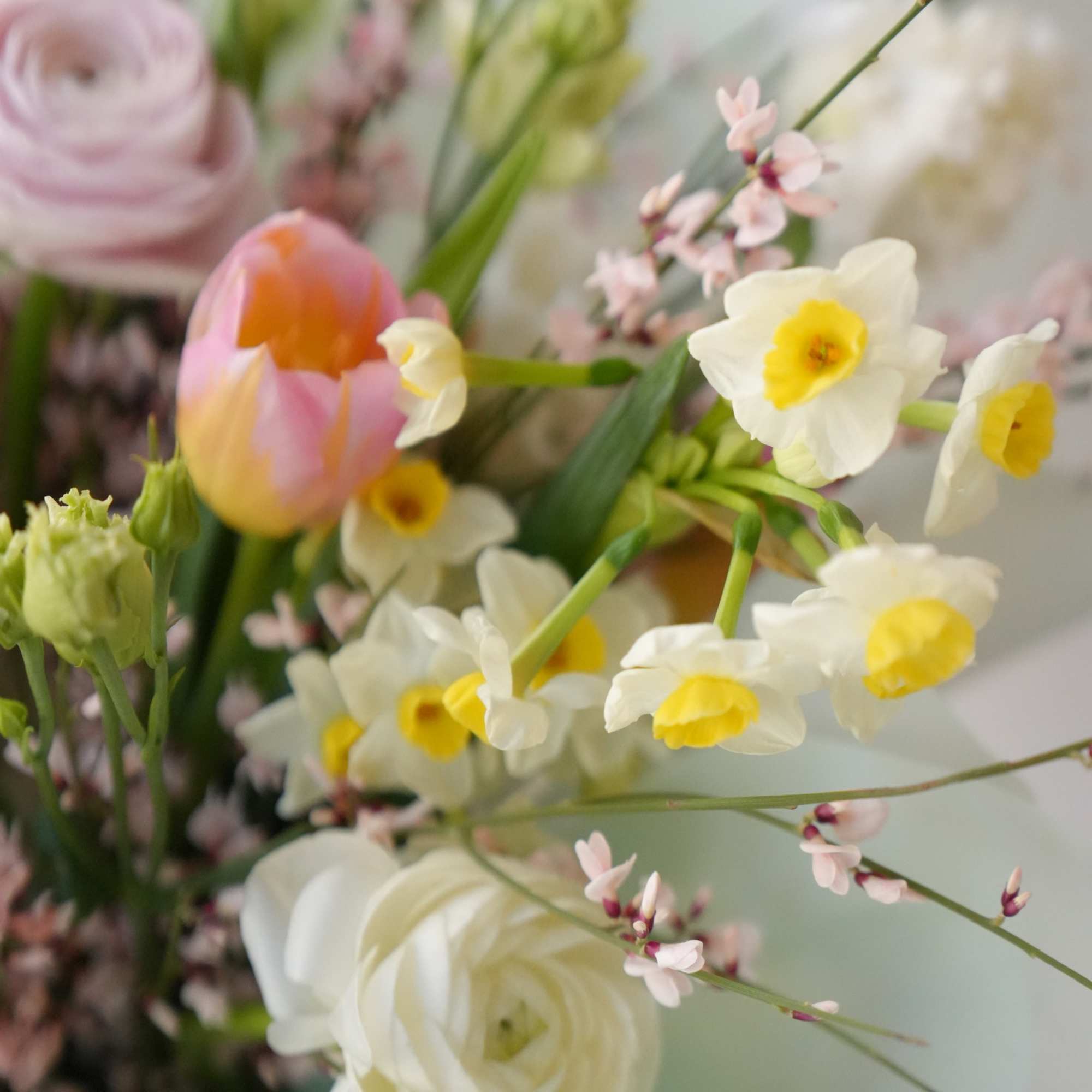 A bouquet made with delicate blooms in various shades of pink, white