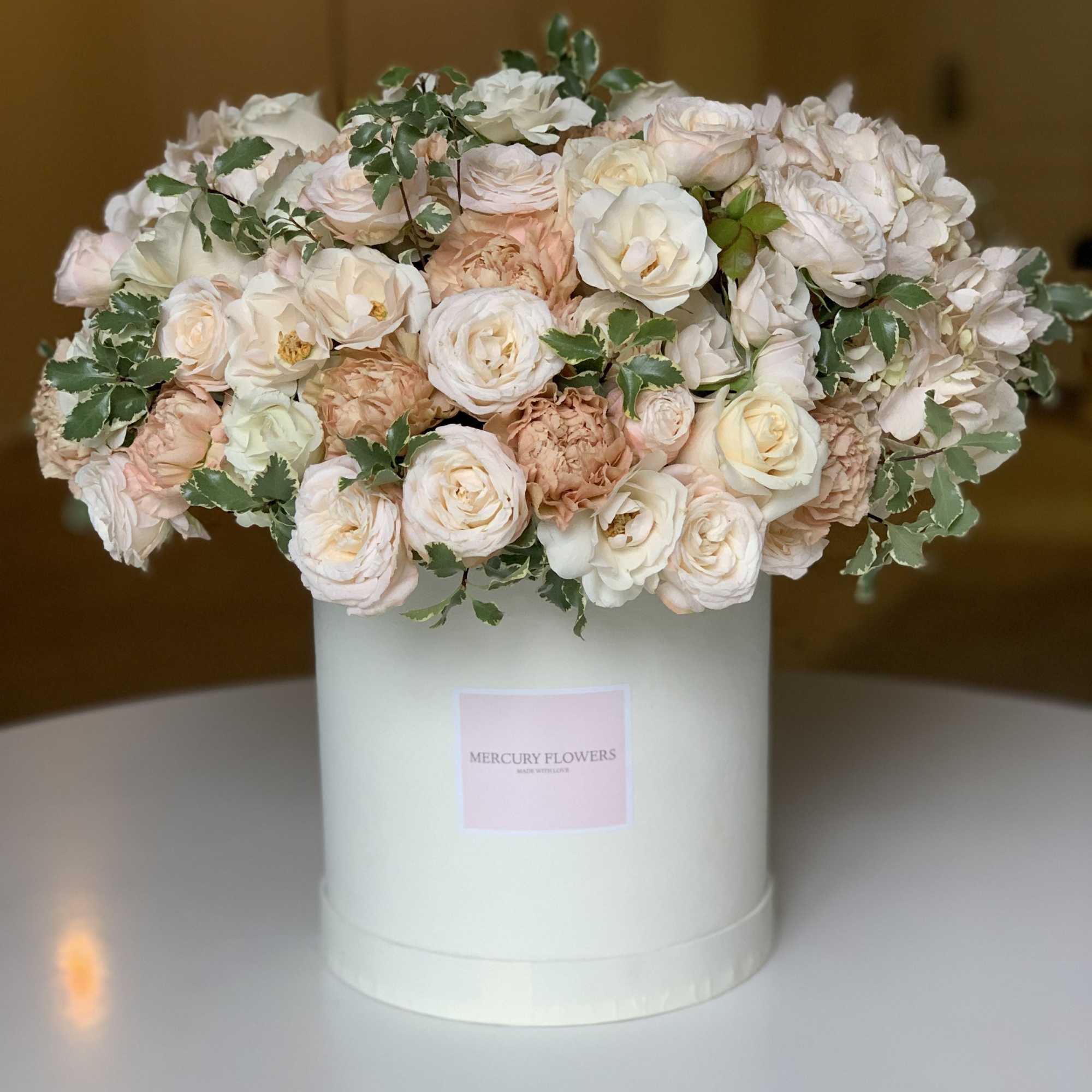 This tender box with white roses, spray roses, hydrangeas, carnations will be