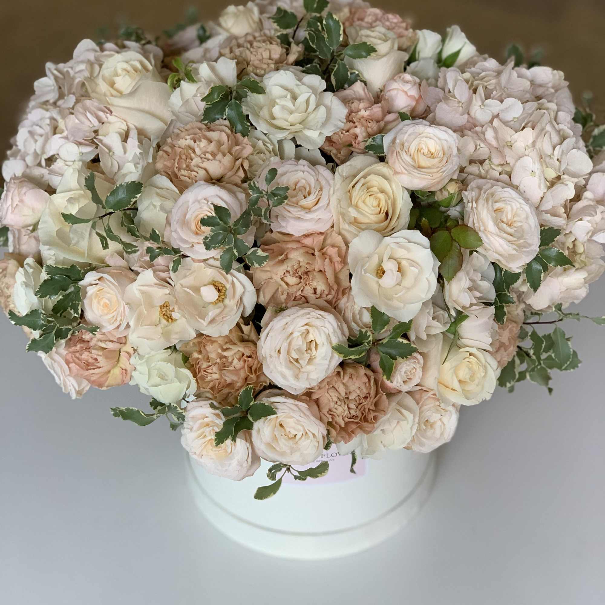 This tender box with white roses, spray roses, hydrangeas, carnations will be