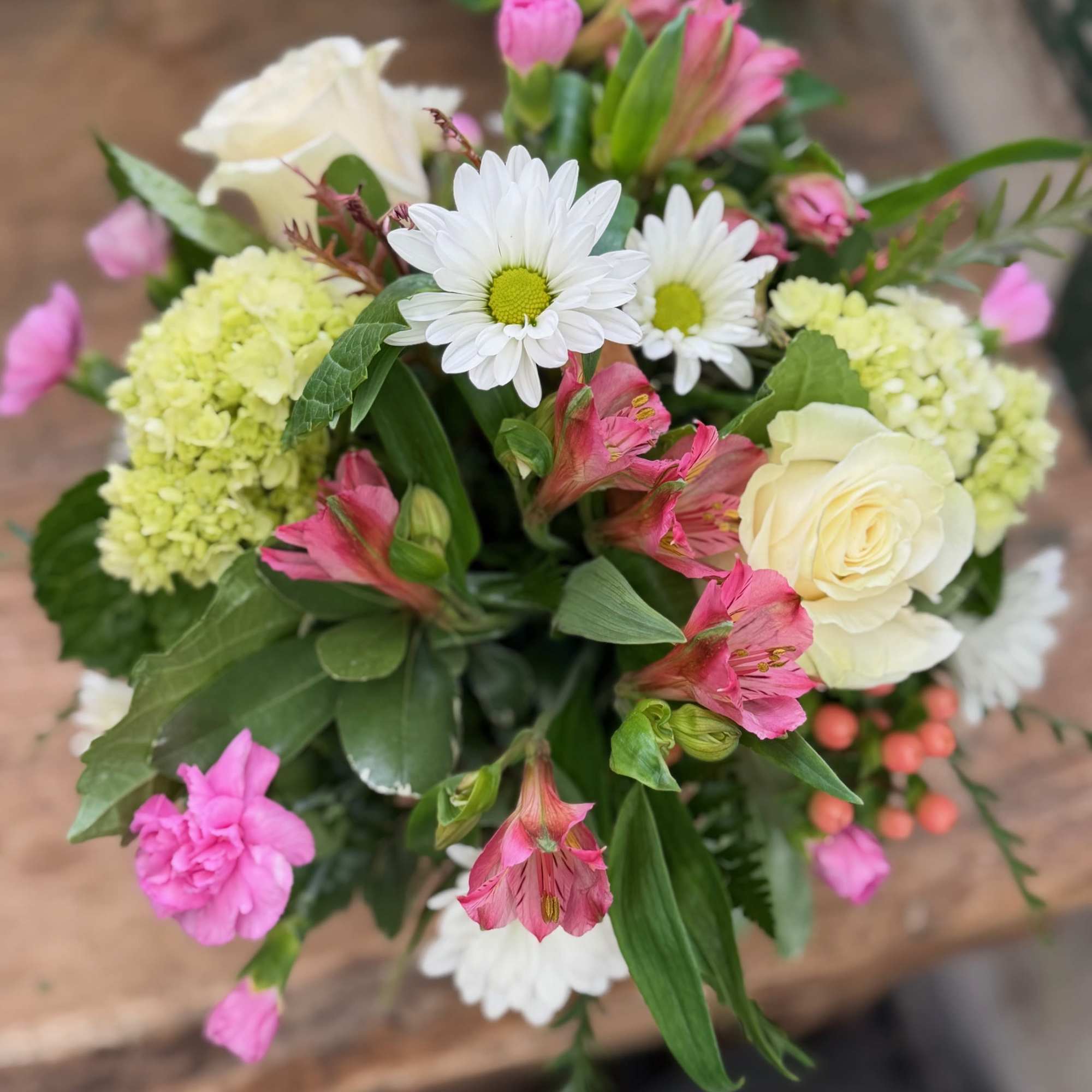 Bouquet of pink and white flowers with daisies and roses