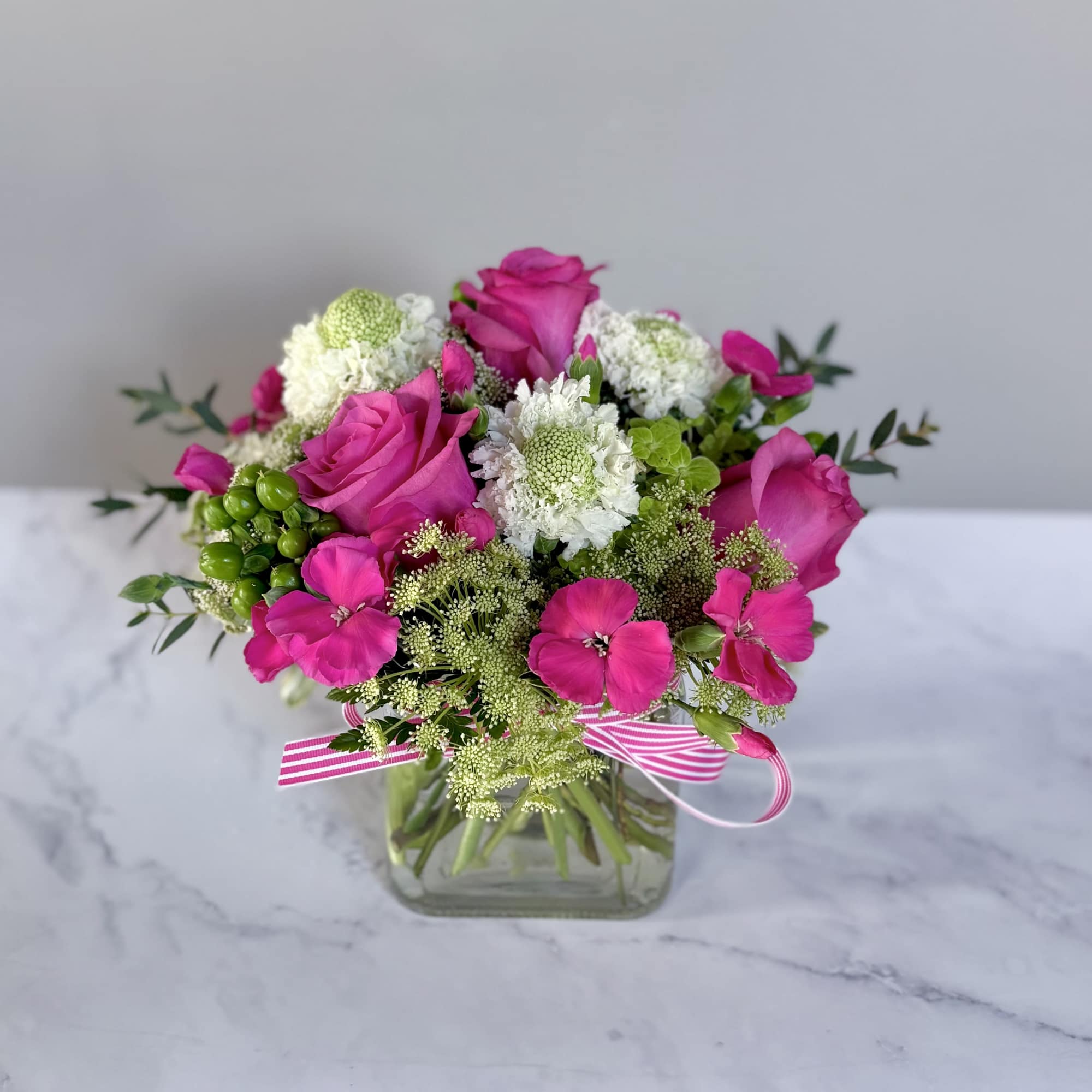 A 5&rdquo; by 5&rdquo; cube filled with a green hydrangea, queen Anne&rsquo;s