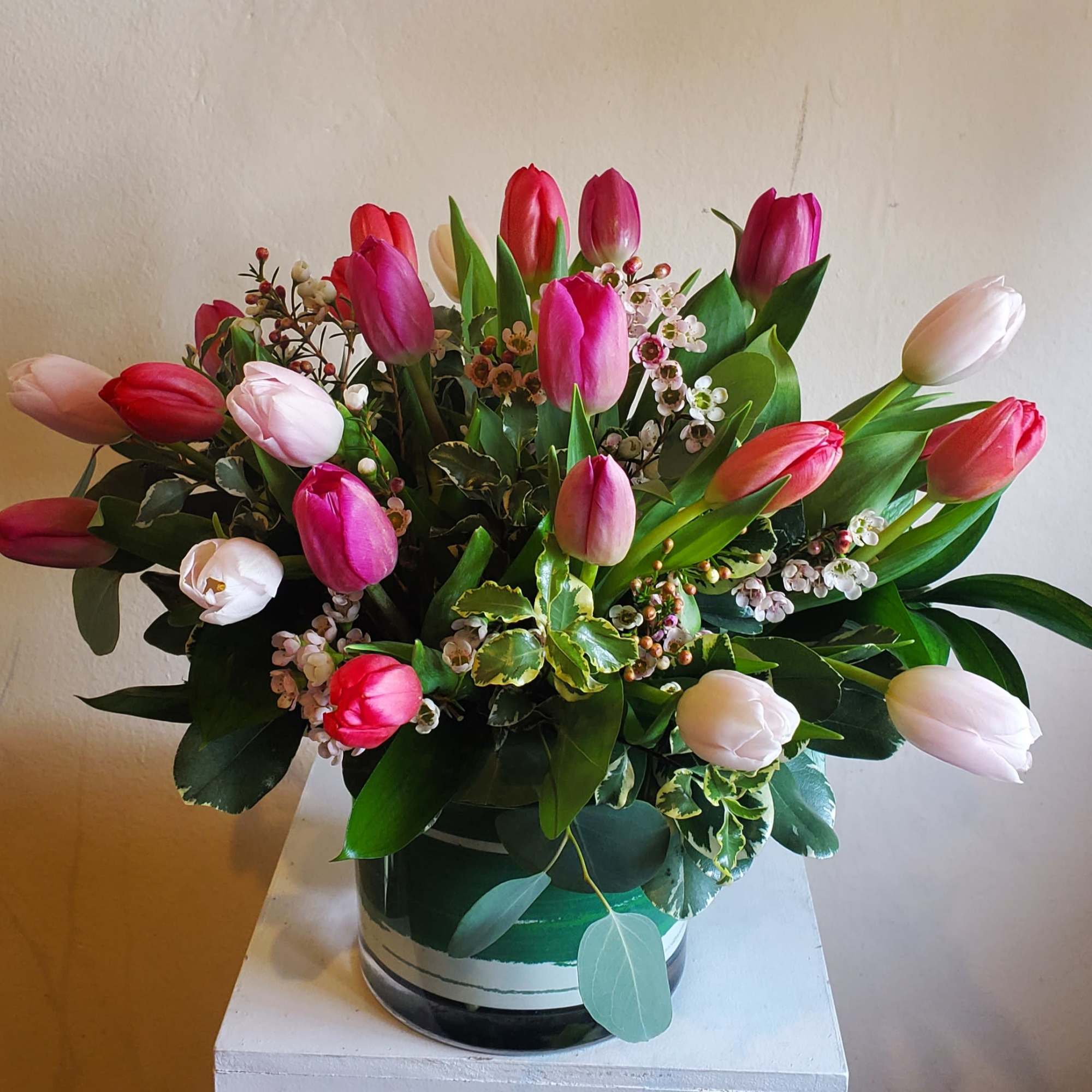 Bouquet of pink and white tulips in a glass vase