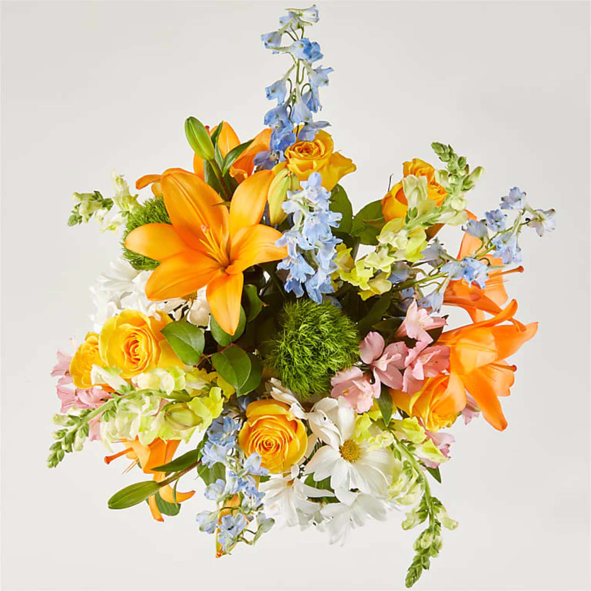 Greet the morning with fresh yellow snapdragons, white daisies, and peach lilies