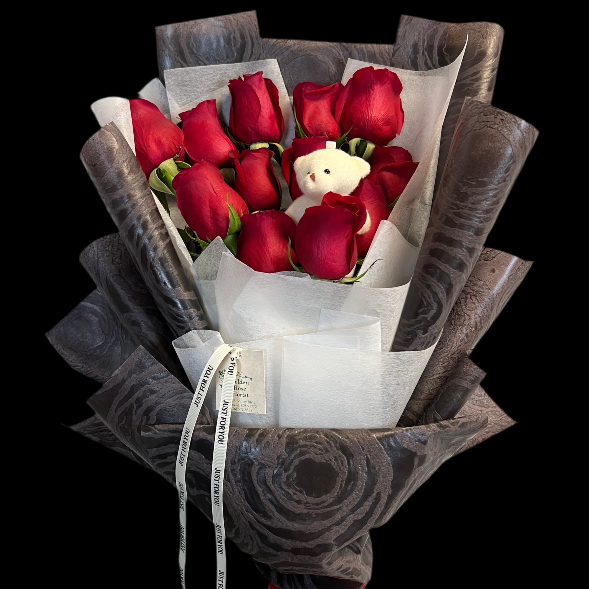 A sleek and sophisticated arrangement of premium red roses, elegantly wrapped in