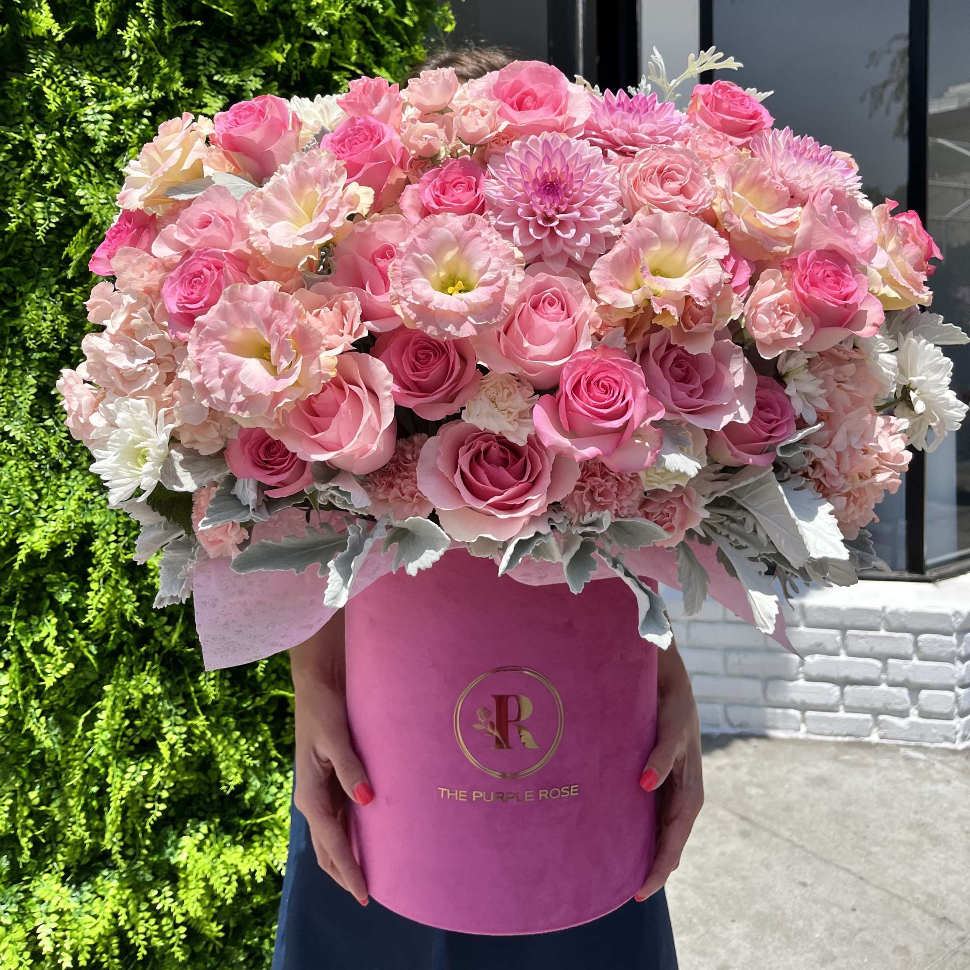 This vibrant floral arrangement is a lush combination of soft pink roses