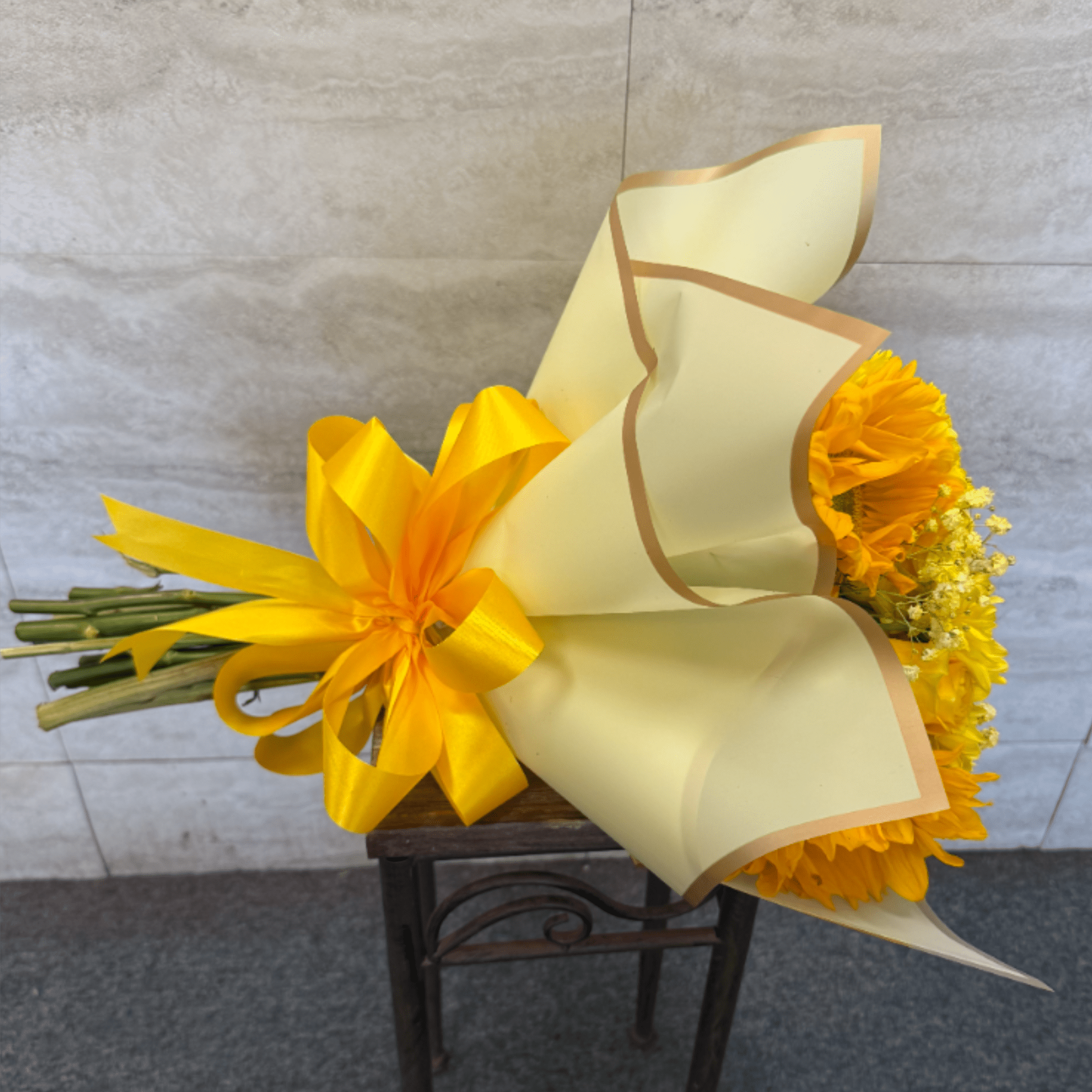 A wrapped bouquet filled with yellow florals, perfect for celebrating Yellow Flower