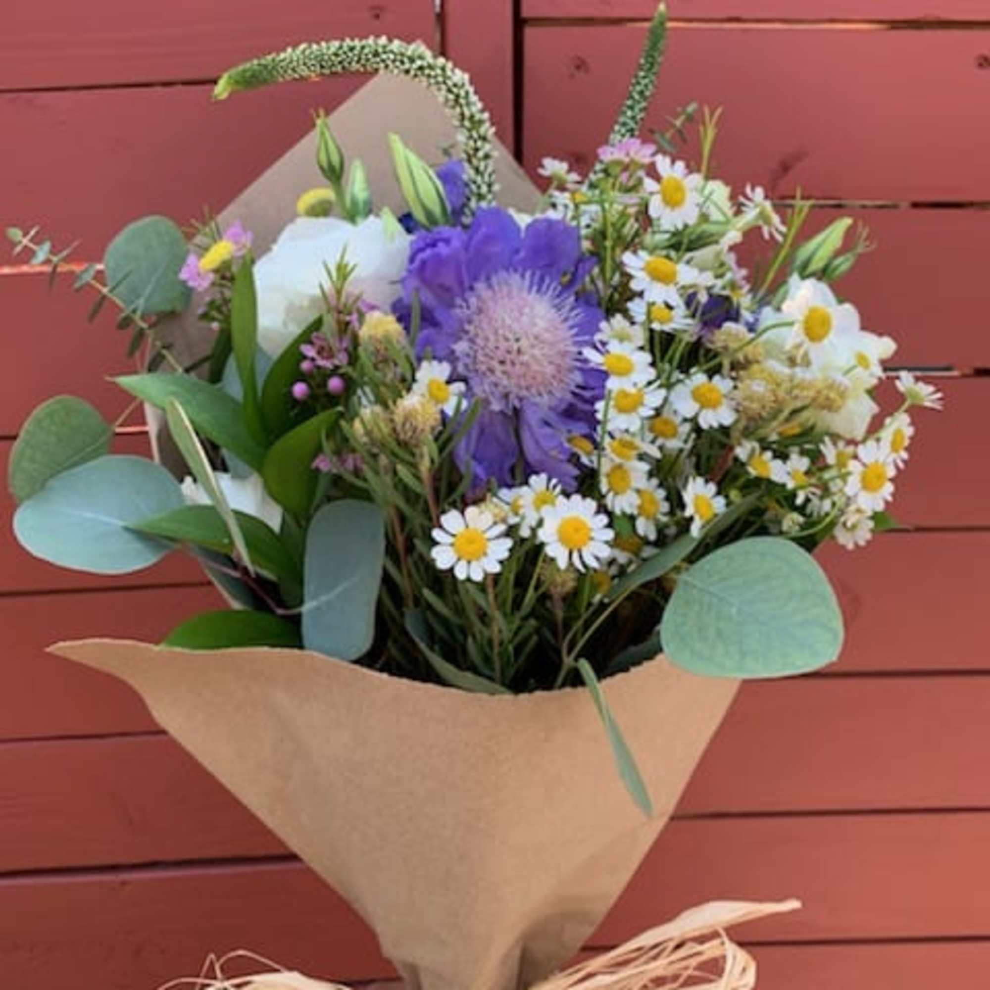 Seasonal wild flowers arranged in a bouquet (no vase). 

Please note, bouquet