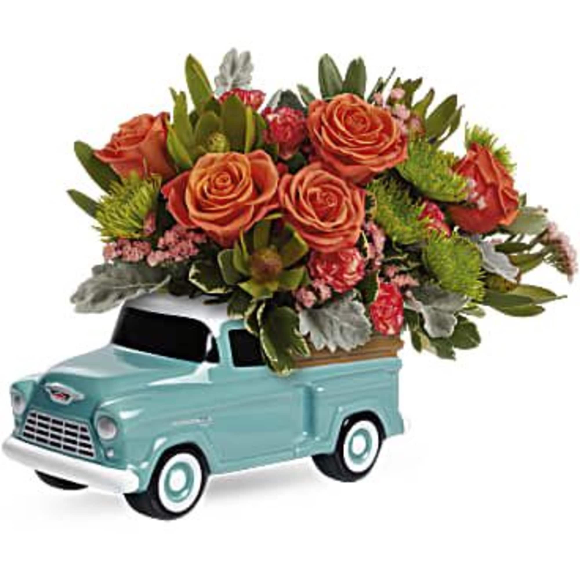 Bursting with a fresh rose bouquet, this sweet, hand-glazed ceramic Chevy keepsake