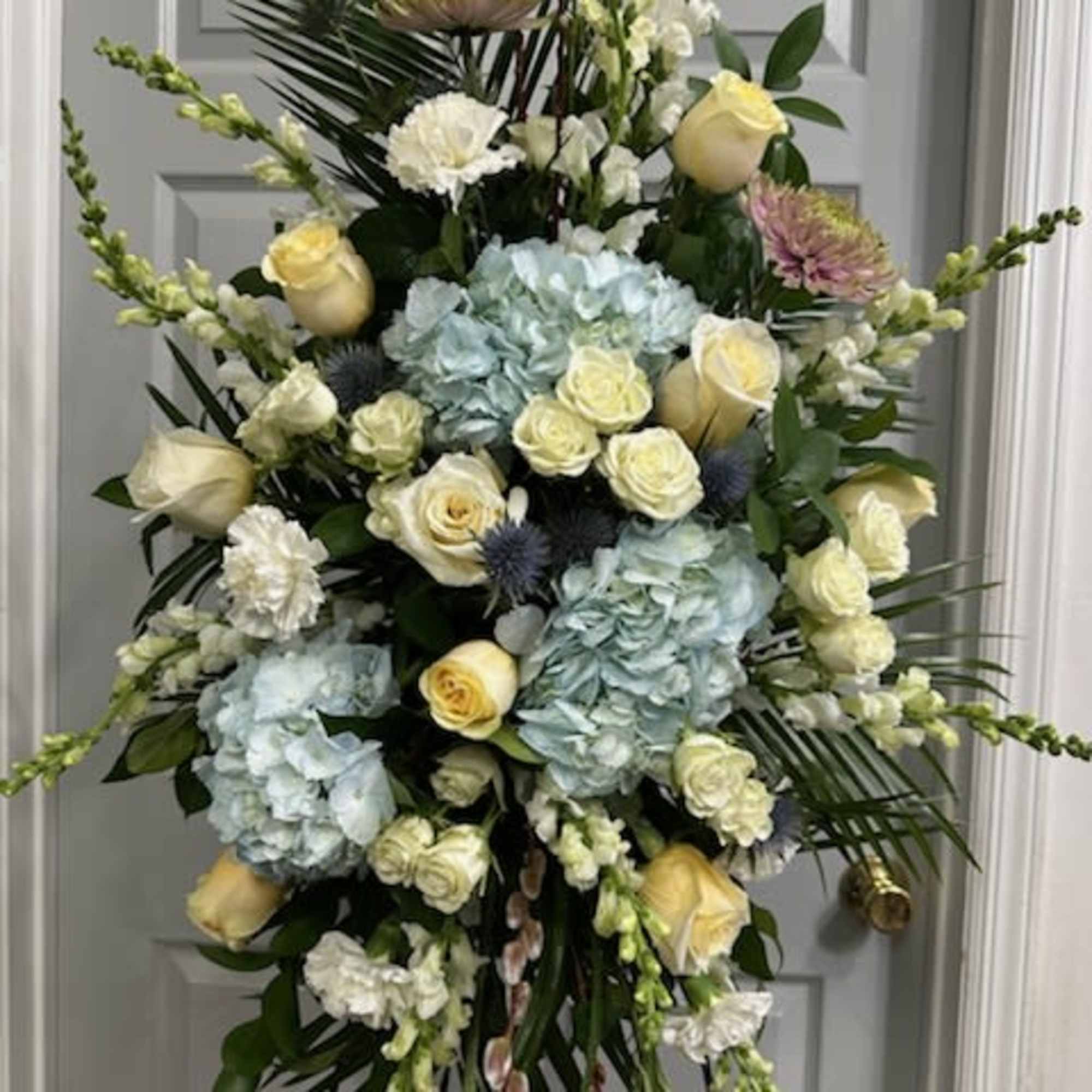 Light Blue Hydrangea, White Roses, Light Yellow Roses, Snapdragons, Stock, Carnations, Fancy