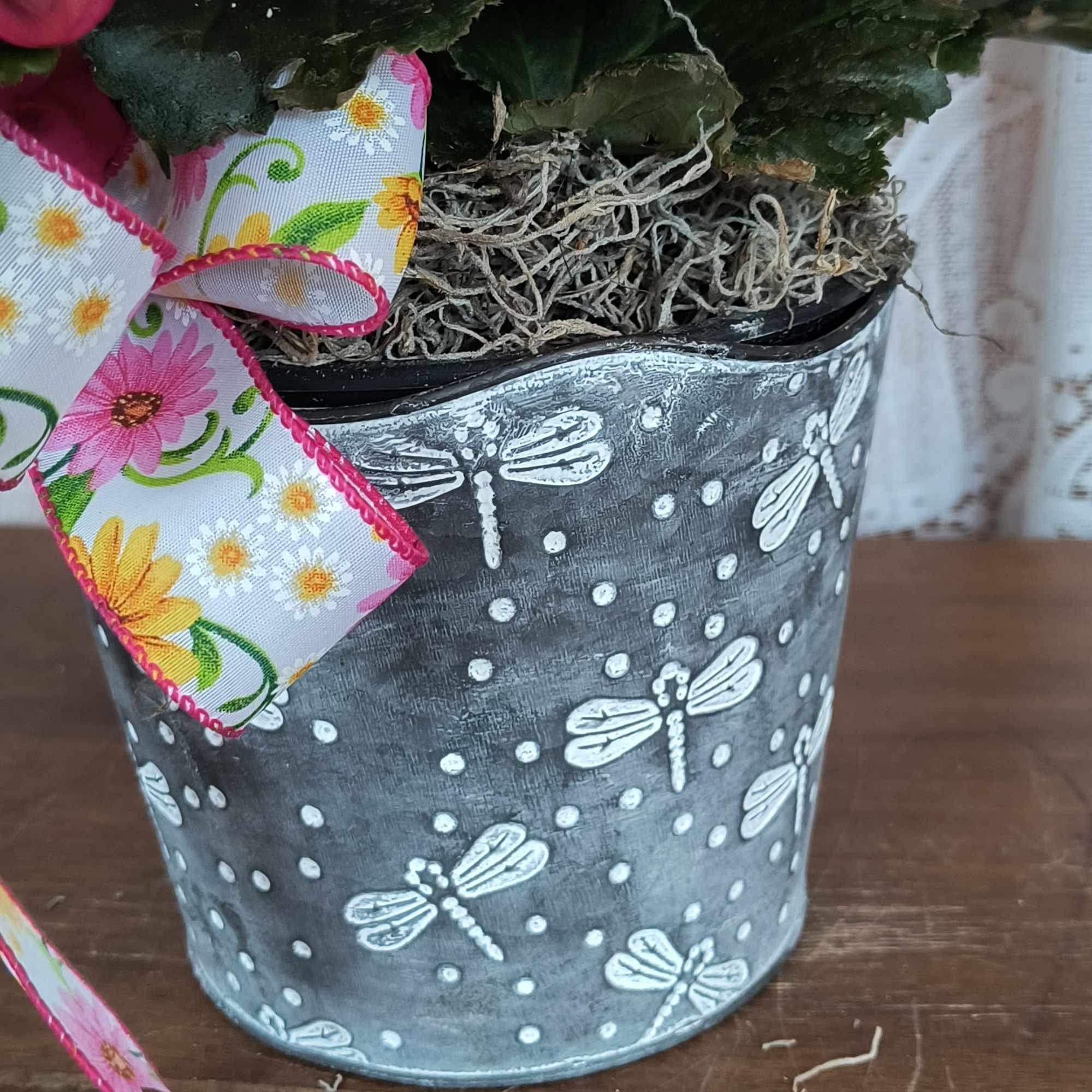 This beautiful blooming plant is full of blossoms arranged in a wicker