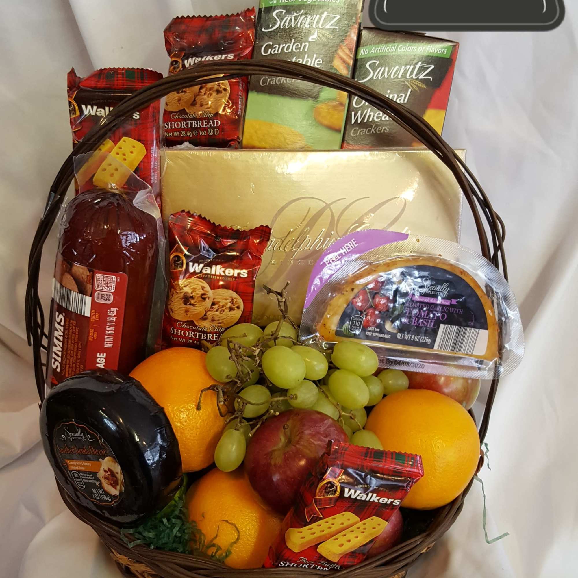 Gift basket with fruit, crackers, cheese, and cookies