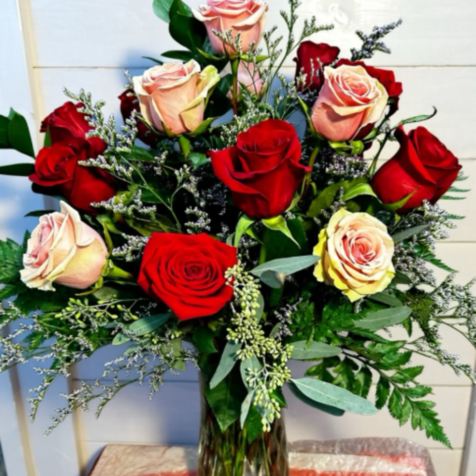 A stunning mixed arrangement featuring a dozen red roses and 6 pink