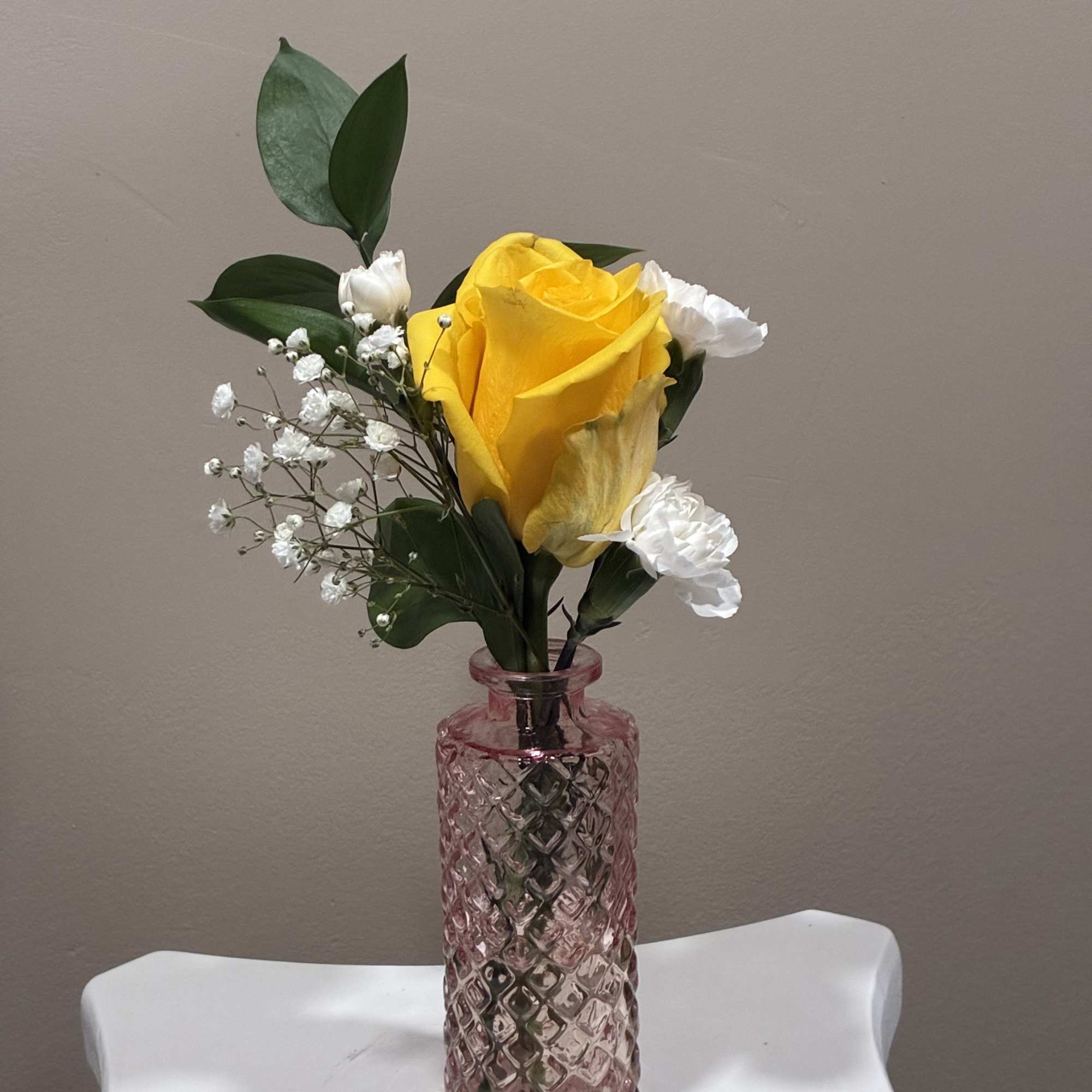 Charming seasonal flowers arranged in classic mason jars create a relaxed, rustic