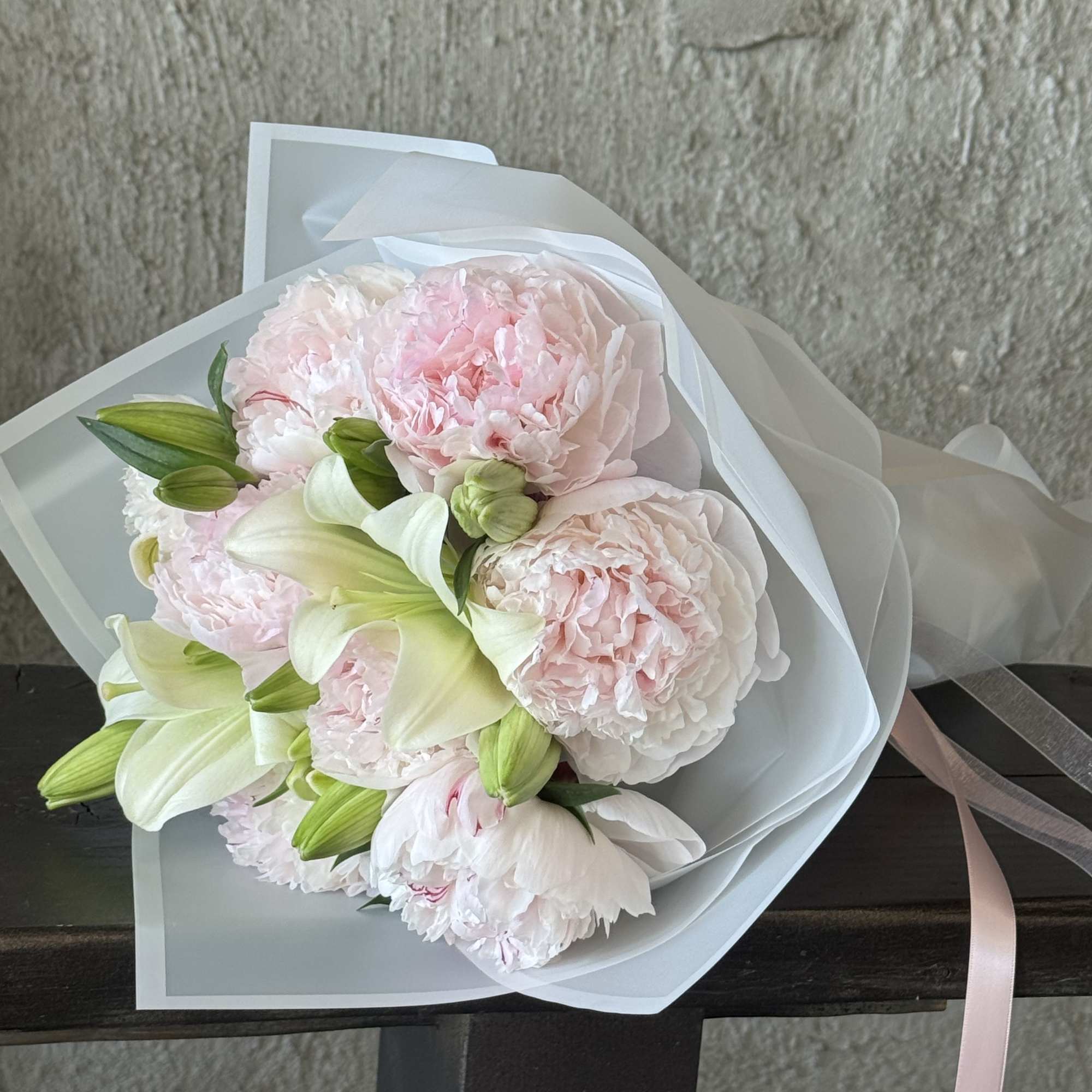 Fresh peony wrapped bouquet. Can be mixed with other textures and greens.