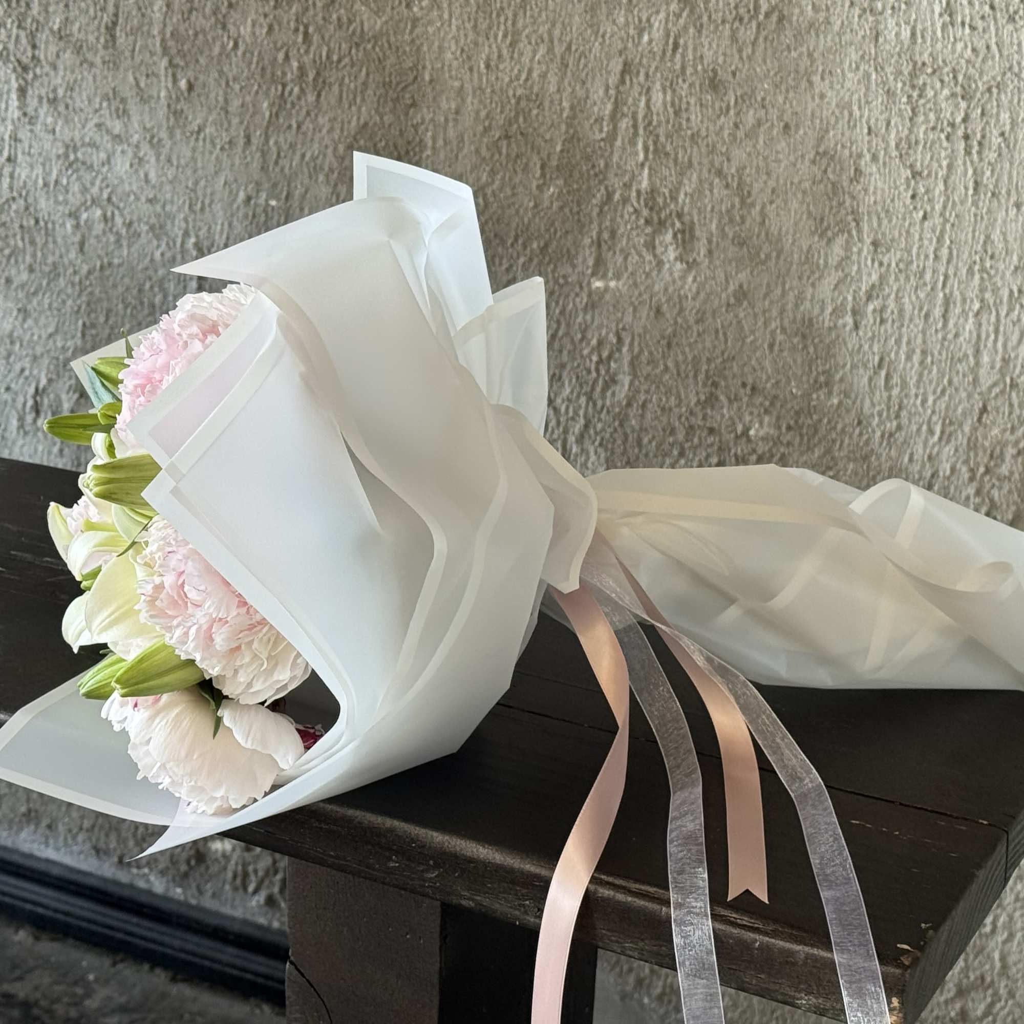 Fresh peony wrapped bouquet. Can be mixed with other textures and greens.