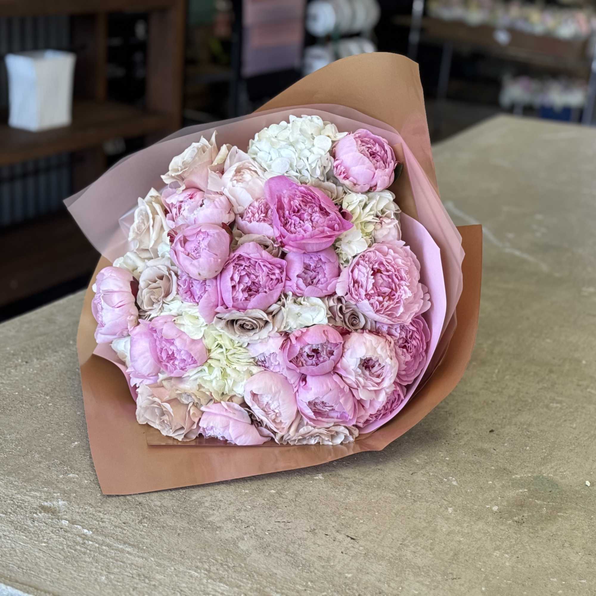 Fresh peony wrapped bouquet. Can be mixed with other textures and greens.