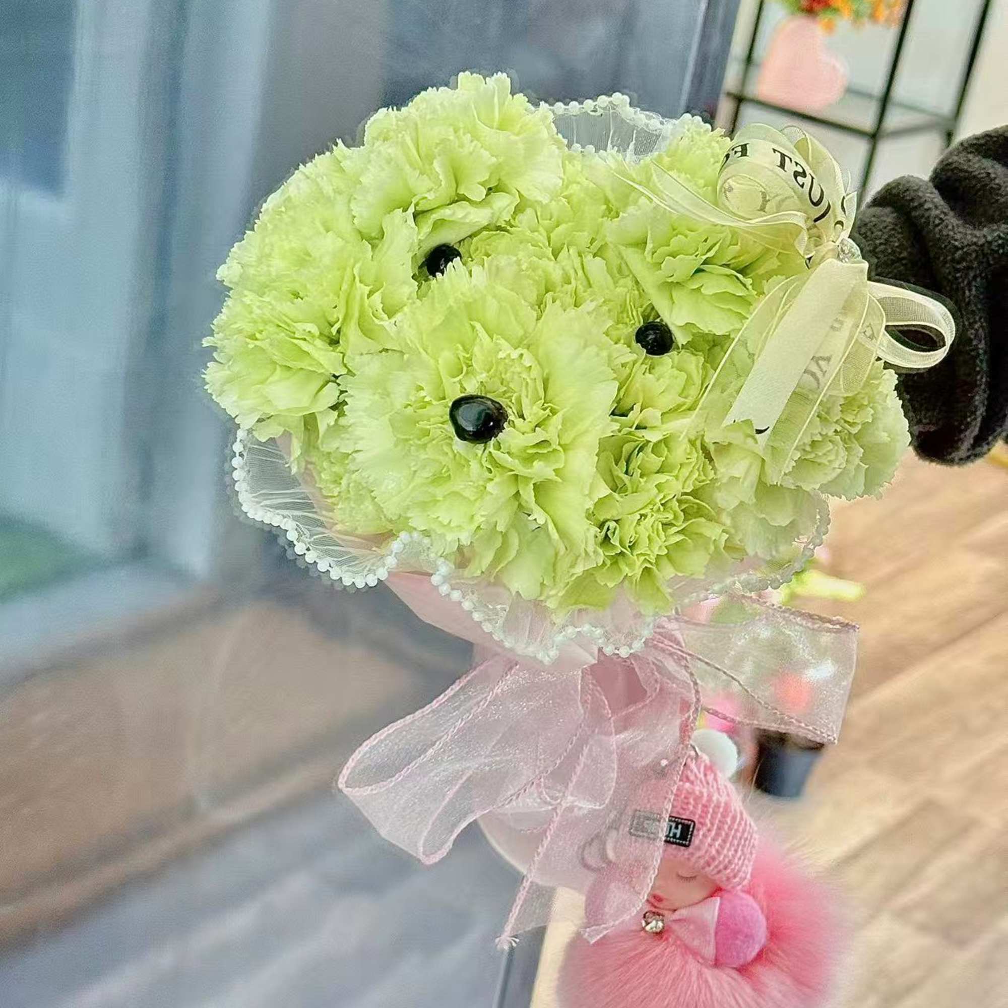 An adorable puppy bouquet crafted from fresh carnations and finished with delicate