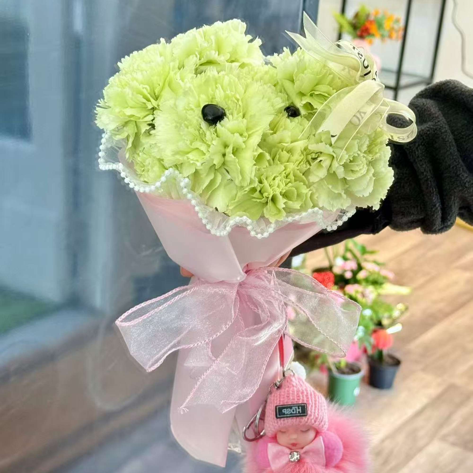 An adorable puppy bouquet crafted from fresh carnations and finished with delicate