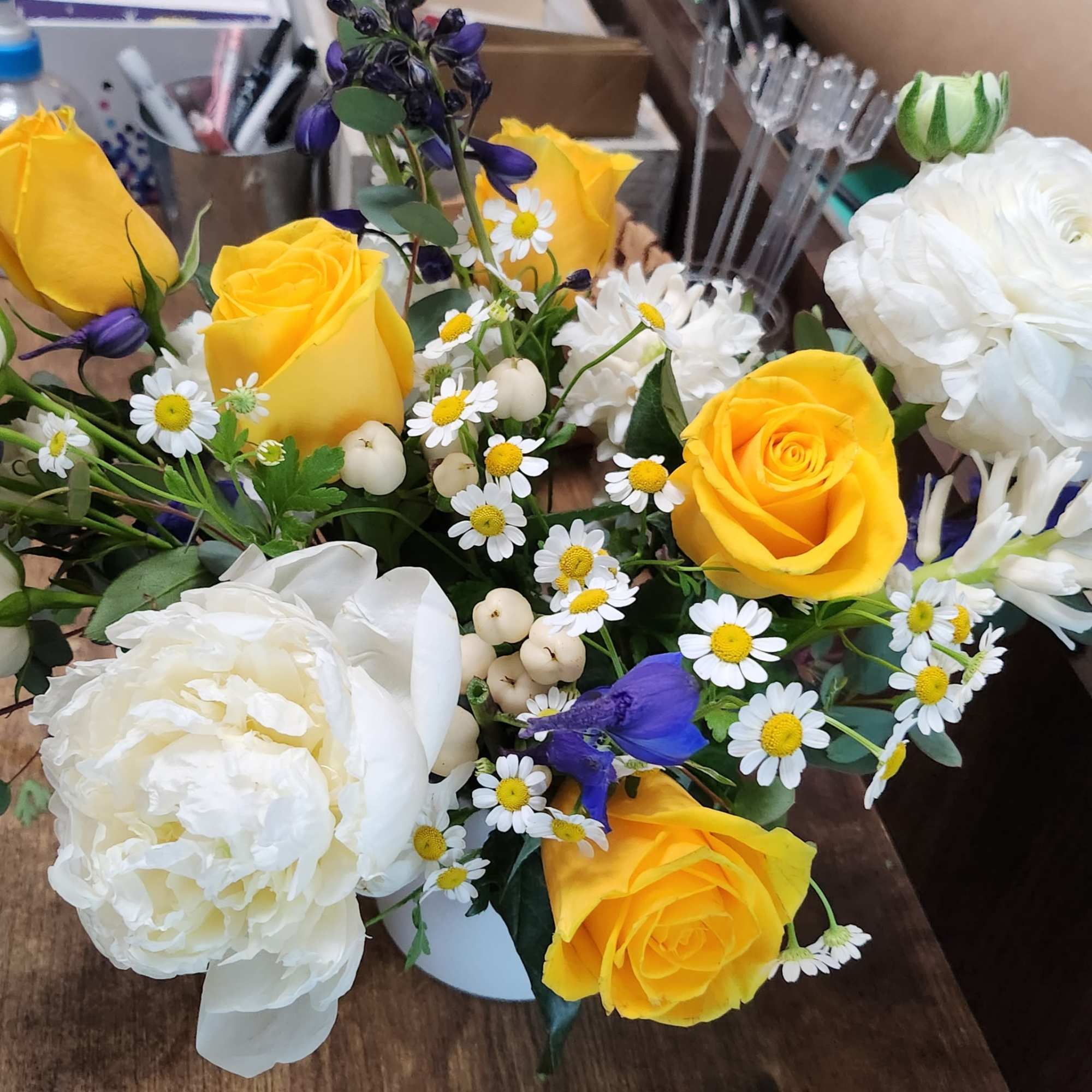 Fresh Blue delphinium and white flower arrangement touch with yellow
