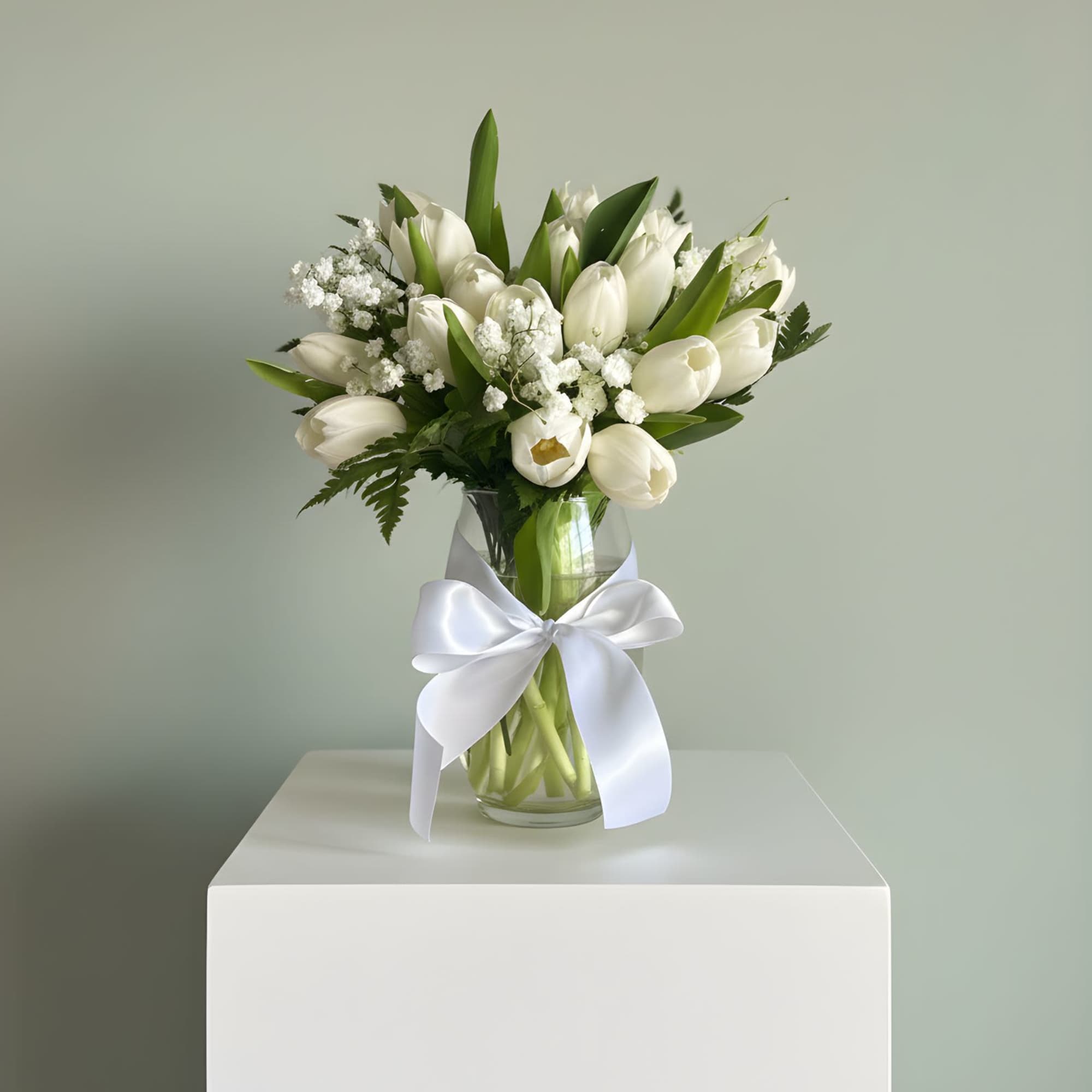 A timeless arrangement of fresh white tulips, delicately accented with baby&rsquo;s breath