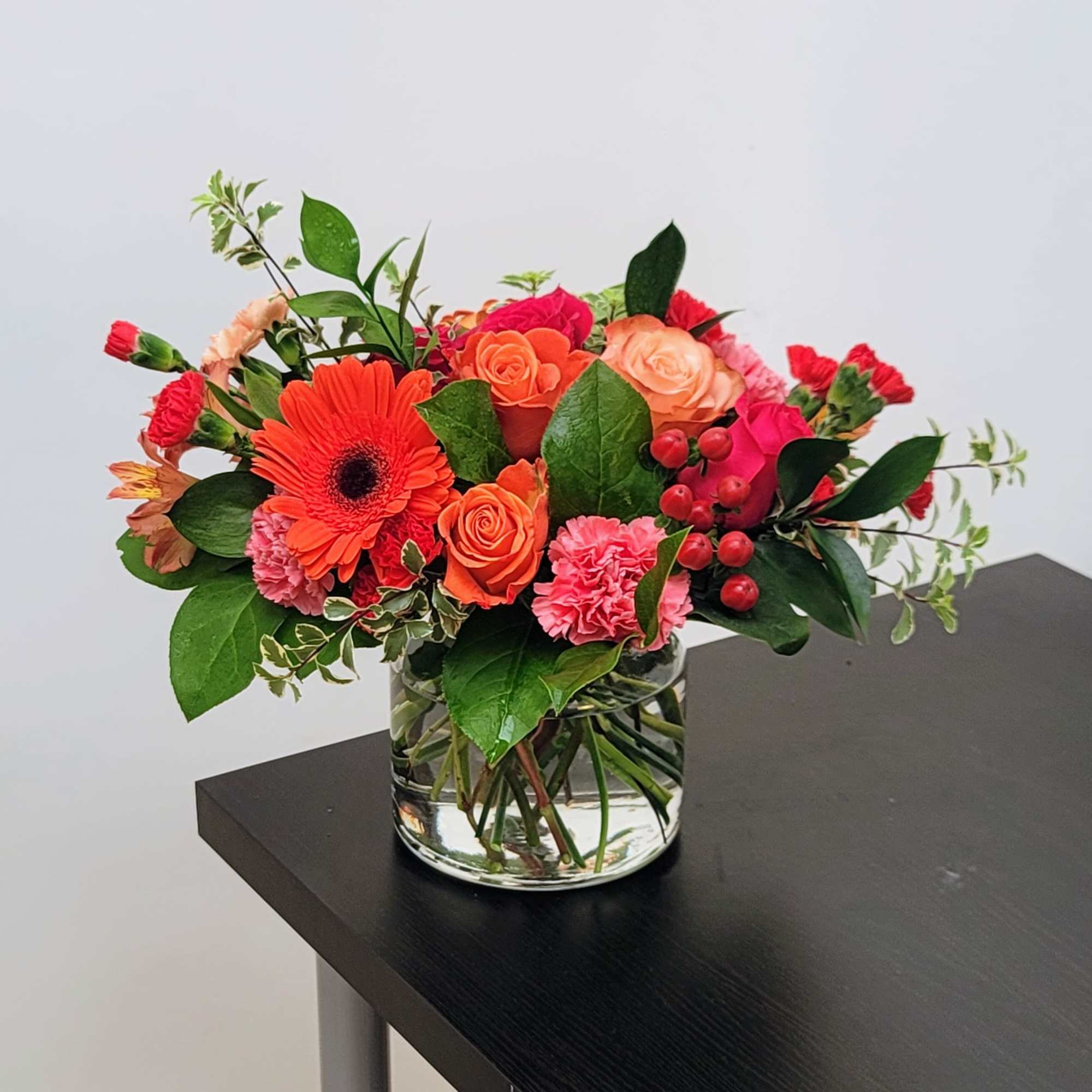Brighten any moment with this vibrant mix of pink and orange roses