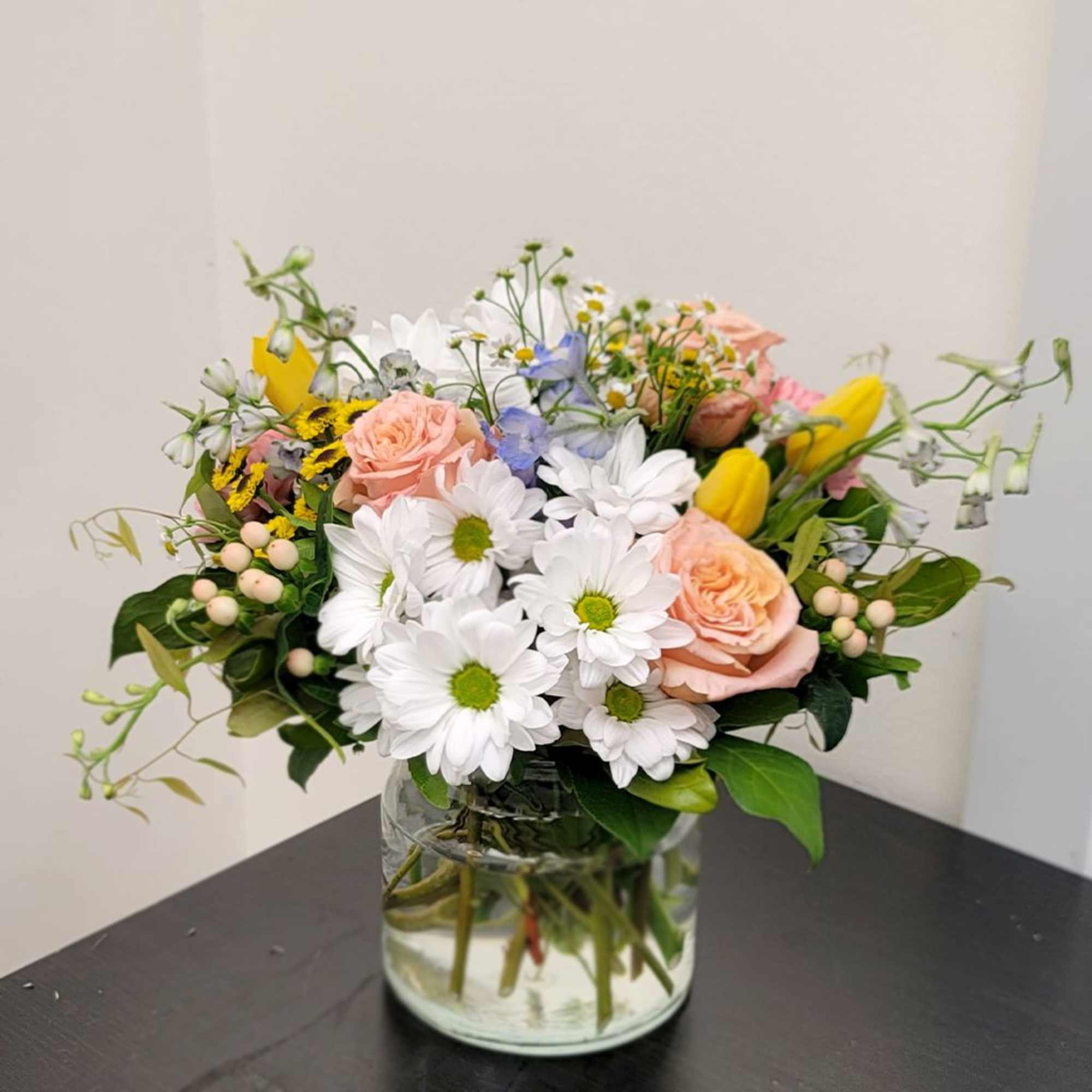 Bright and uplifting, this refreshing bouquet features vibrant yellow tulips, cheerful white