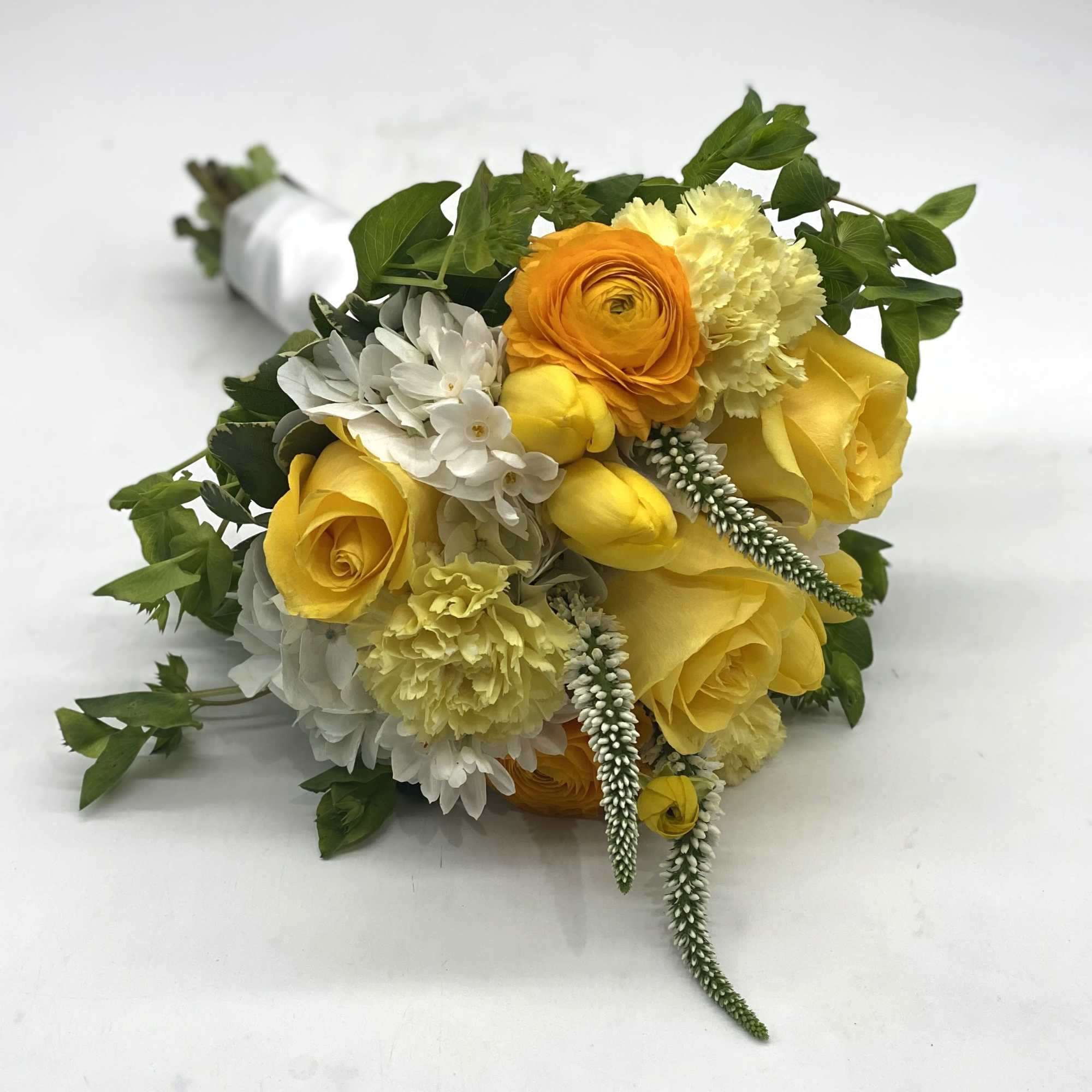 A lush mix of yellow rose, tulips, ranunculus, carnations and more!