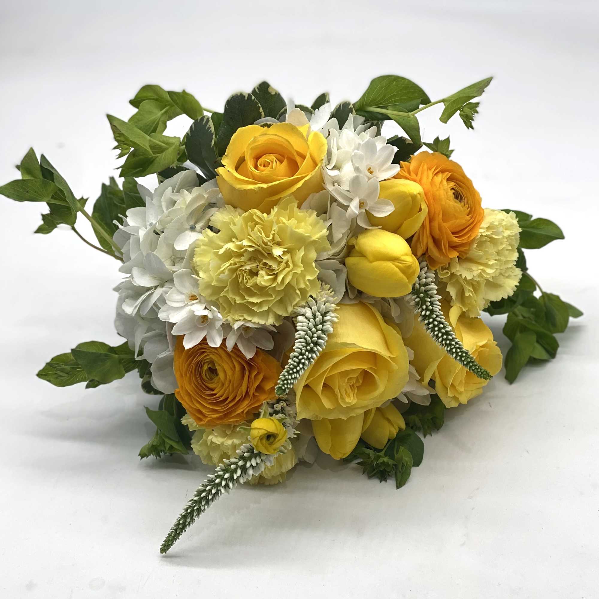 A lush mix of yellow rose, tulips, ranunculus, carnations and more!