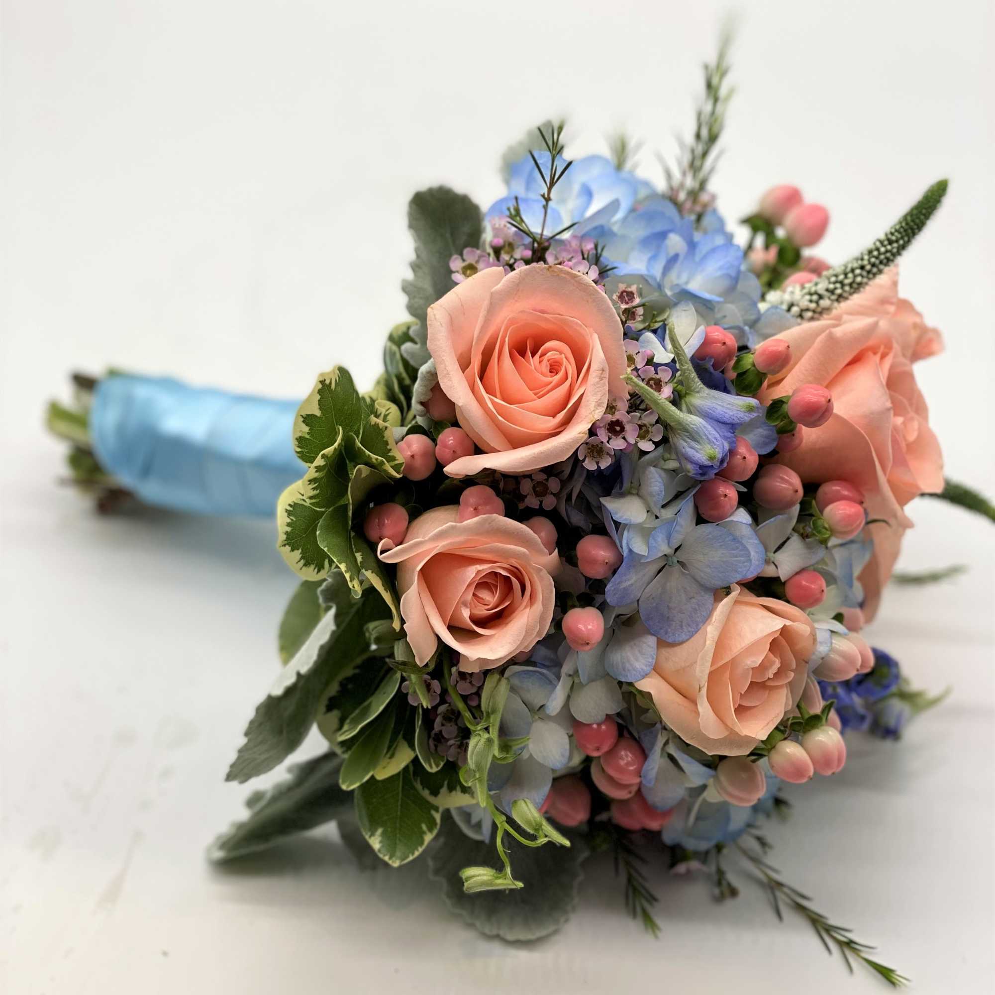 A gorgeous combination of blues and corals makes this bouquet stand out!!