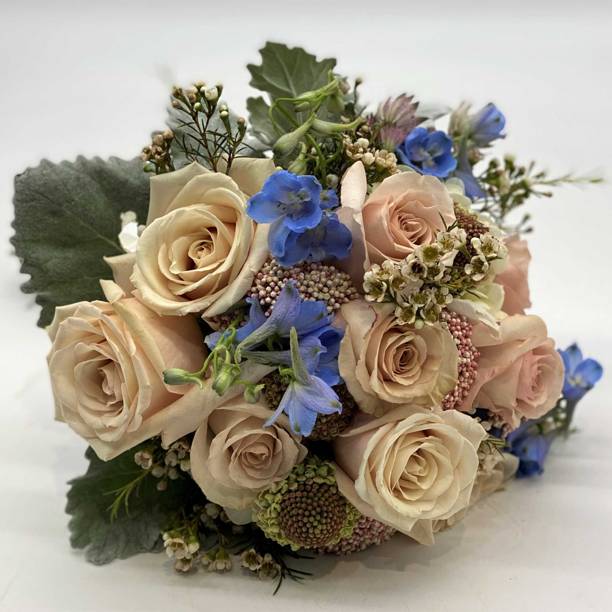 The dusty coloring of this bouquet with the touch of pale blue