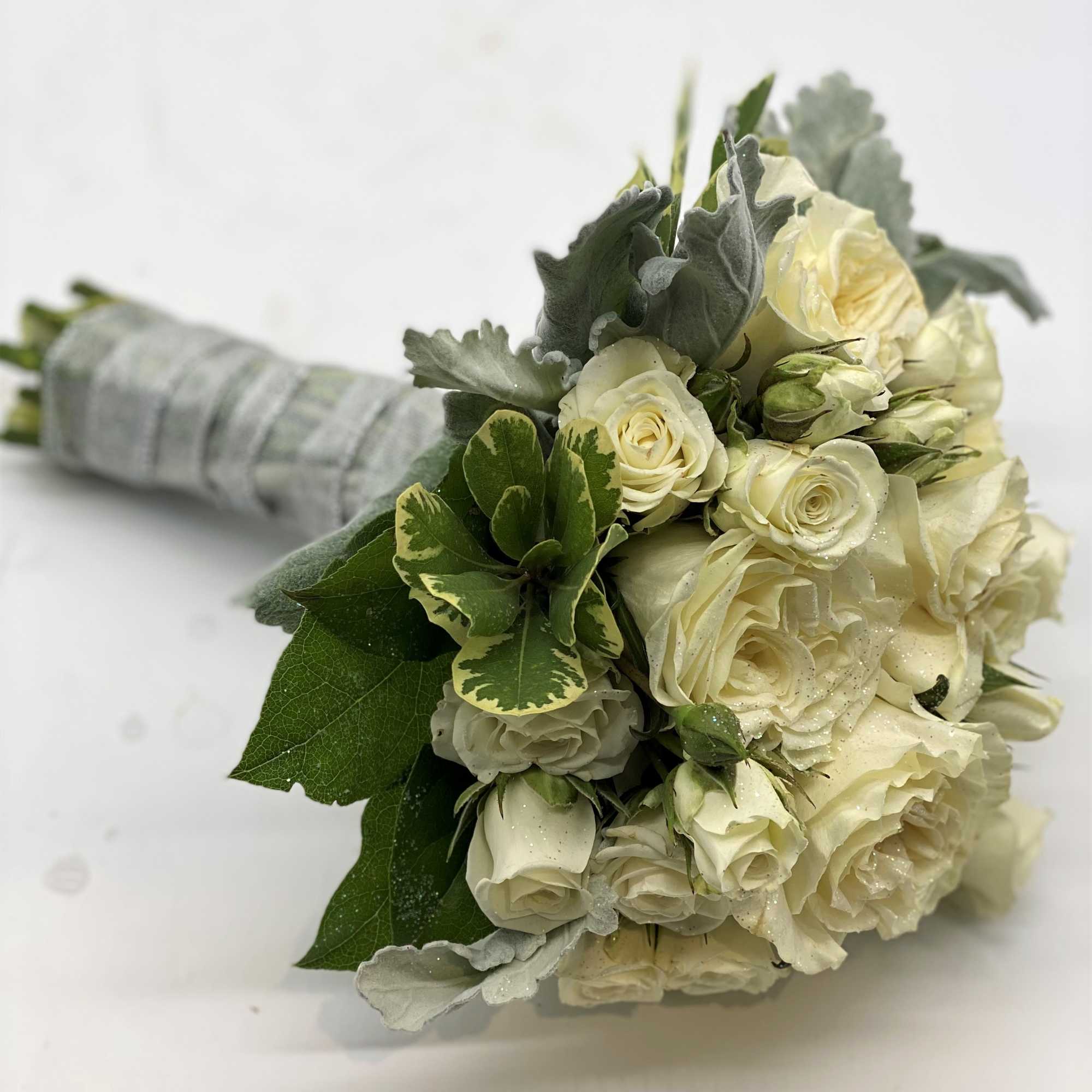 A lush mix of whites and creams, with dusty miller accent and