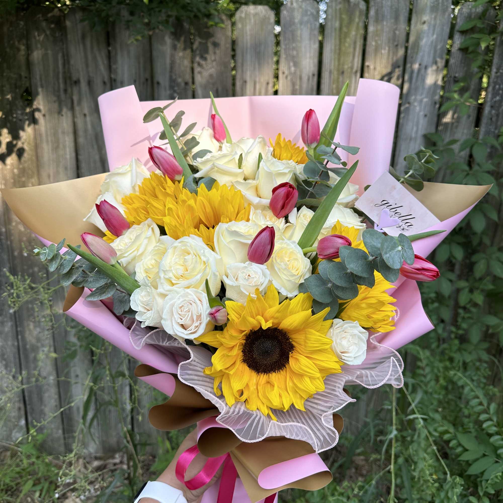 All in one bouquet, roses sunflowers tulips eucalyptus.

Tulips color will depend on