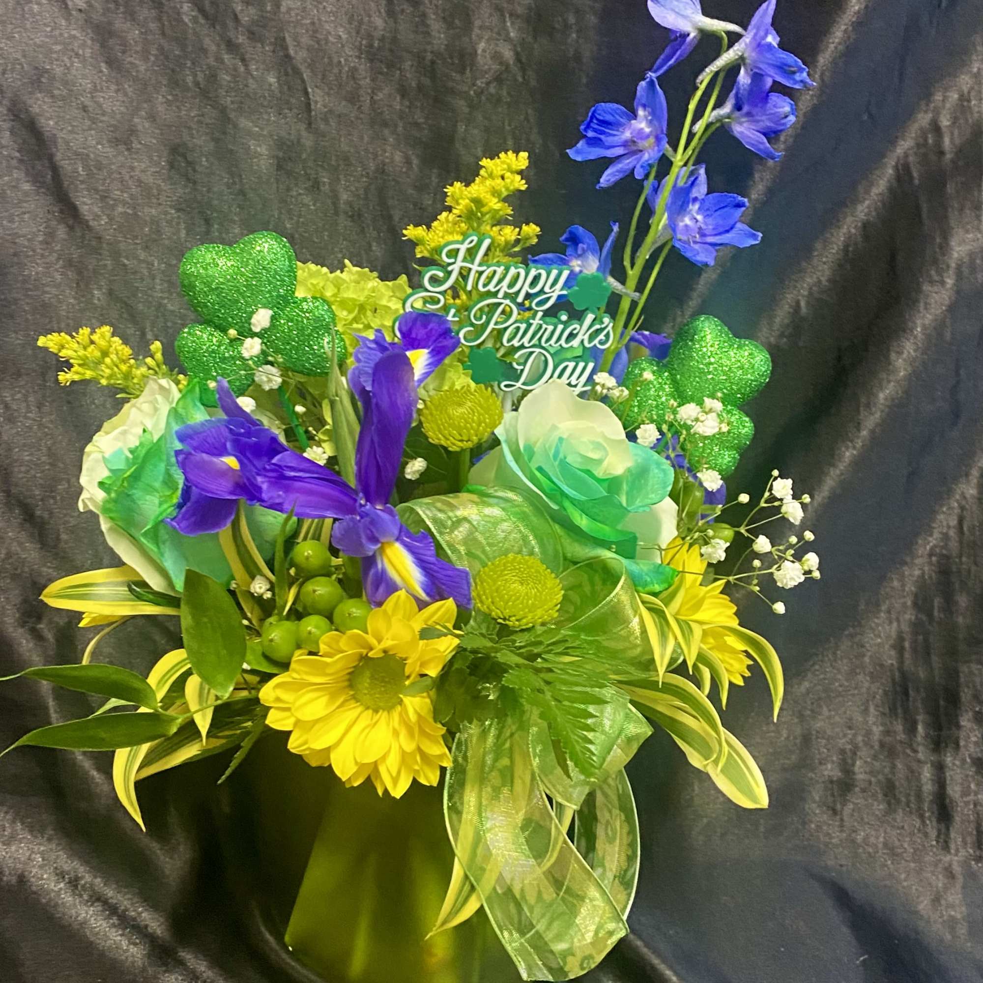 Green themed.  With sunflower,  roses. blue delphinium etc  