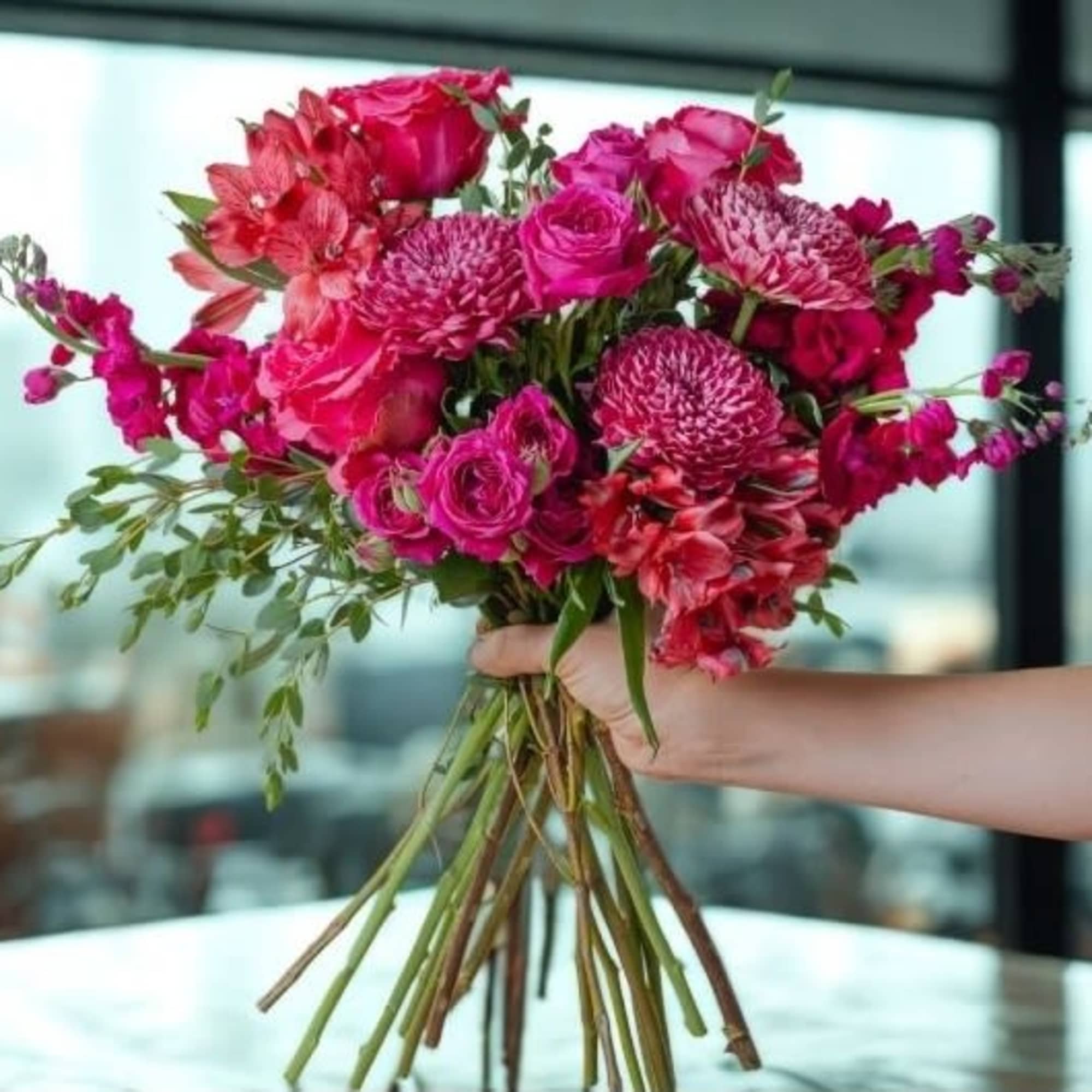 A bold mix of rich pink and cherry-toned blooms, thoughtfully arranged to