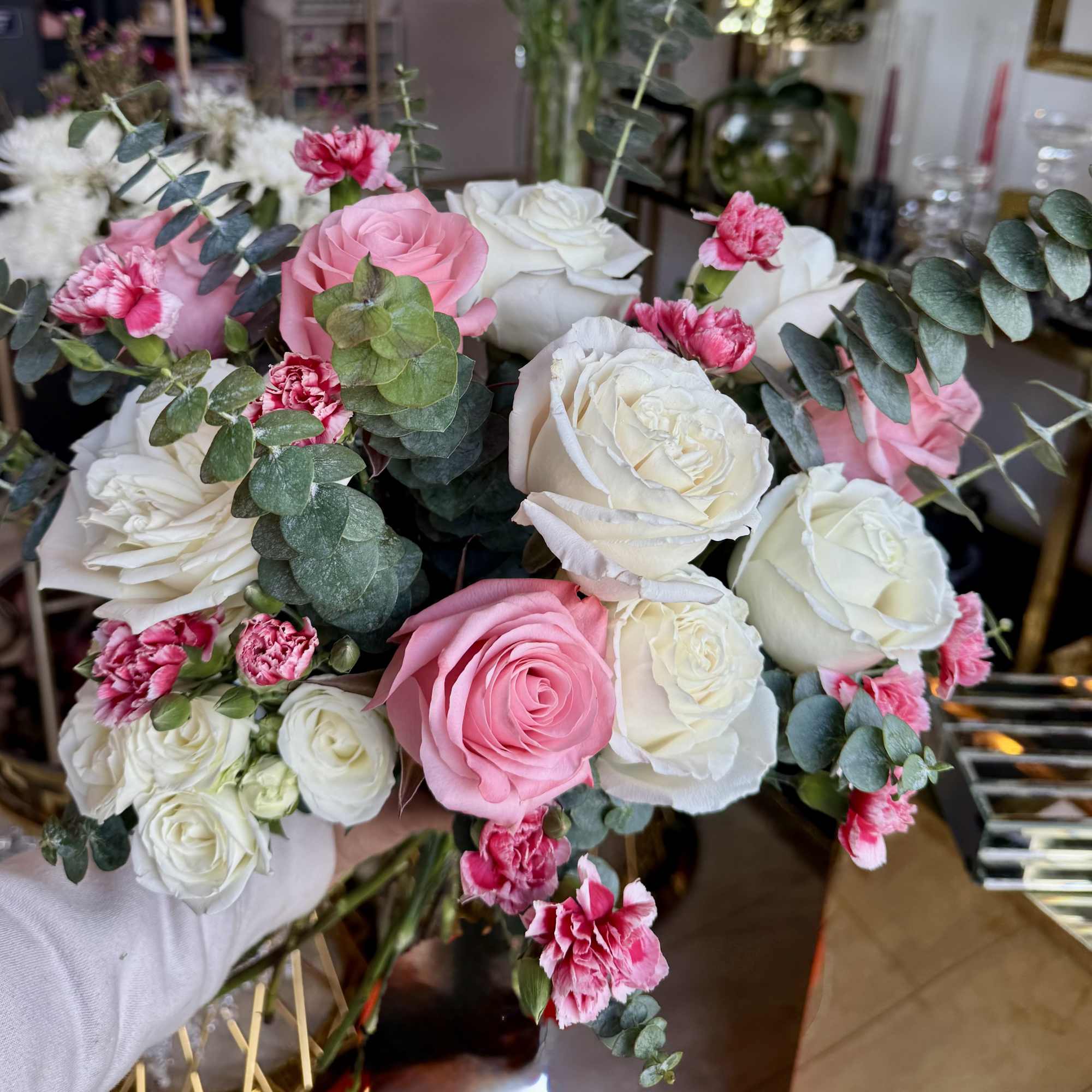 Bouquet of pink and white roses with pink carnations and eucalyptus