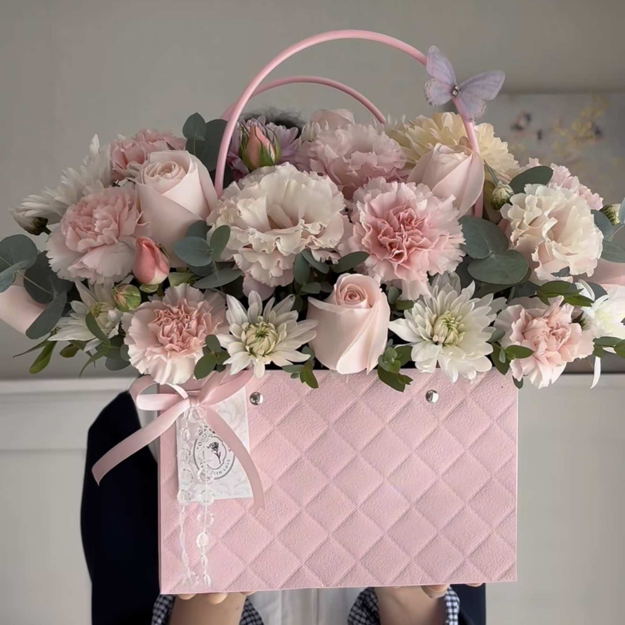 Pink flower box arrangement with roses, carnations, and daisies