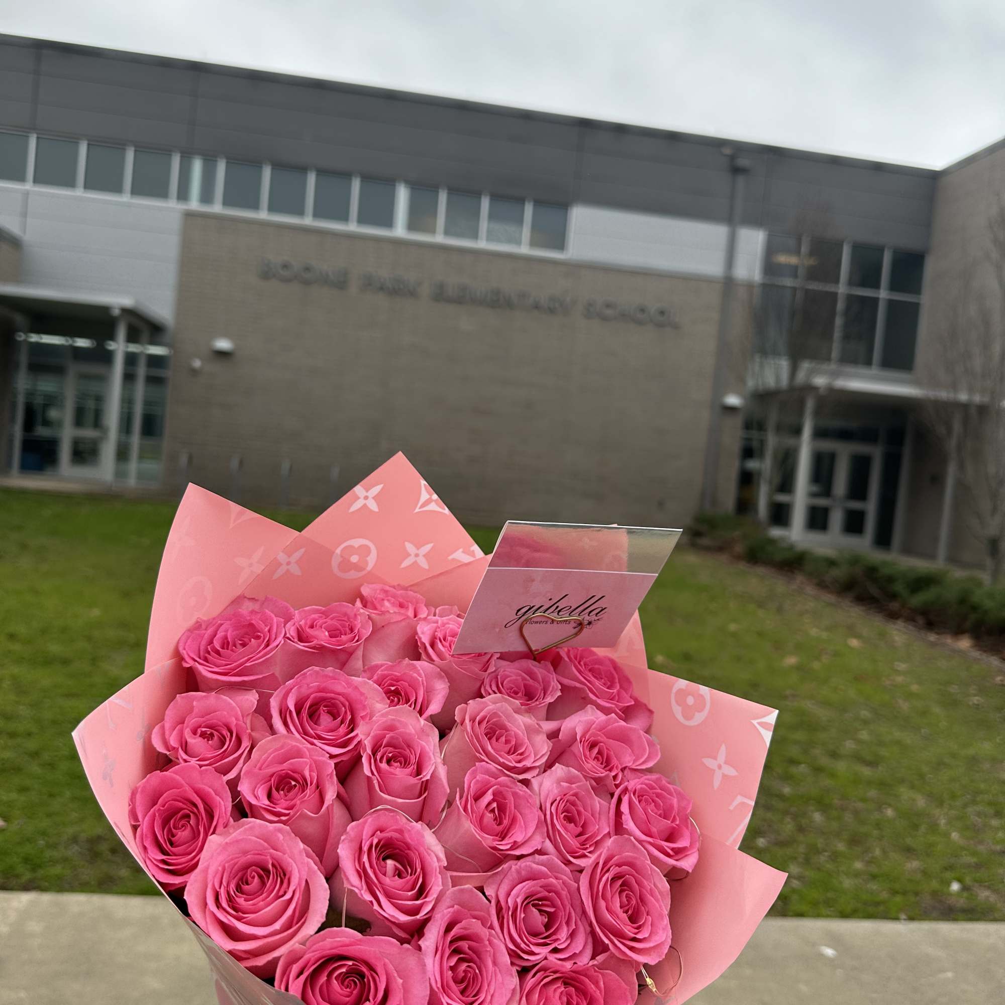 Bouquet of bright pink roses wrapped in pink paper